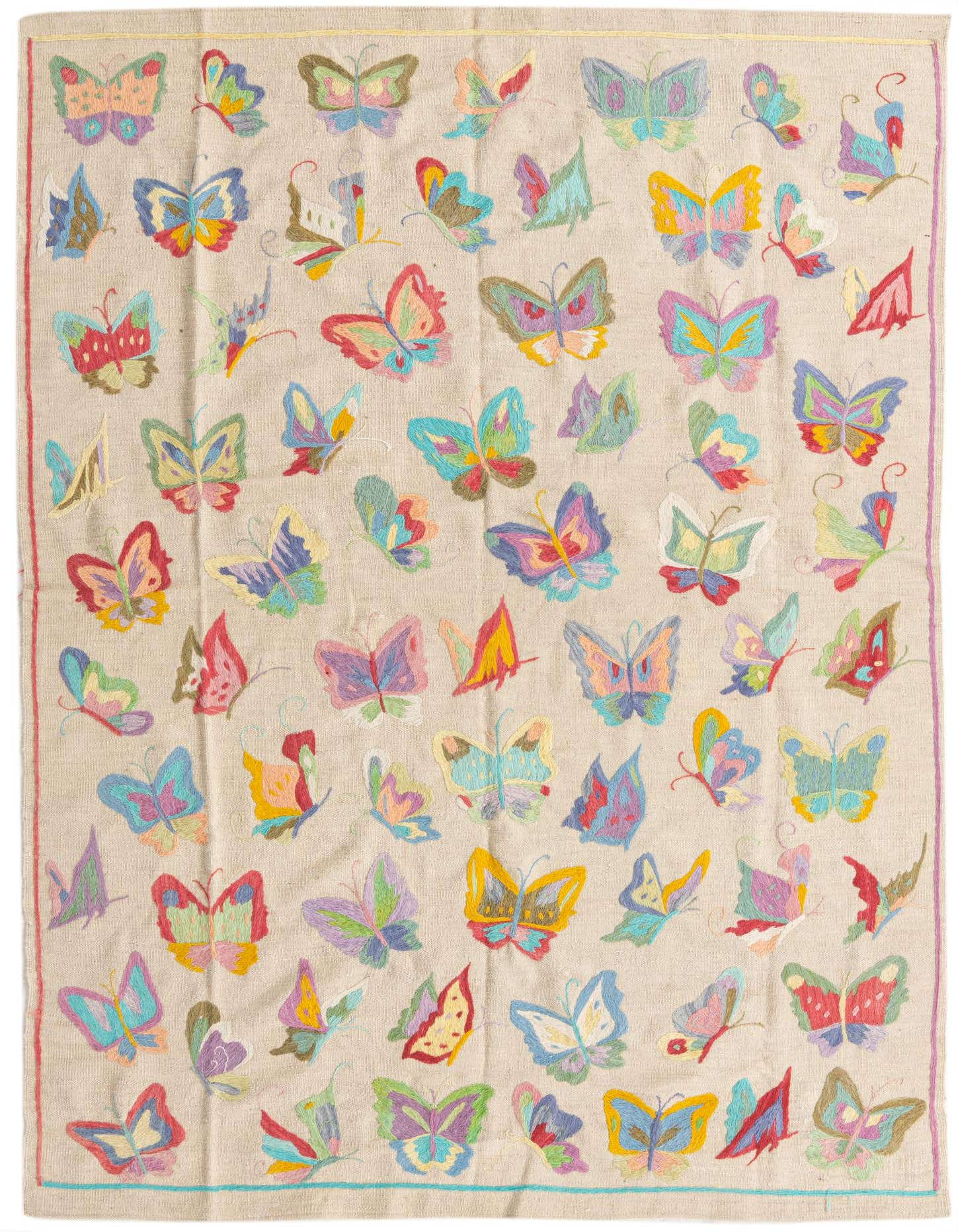 A 5x8 rectangular Kilim Suzani rug featuring a beige background with numerous colorful, embroidered butterflies in various sizes and orientations, showcasing a vibrant, whimsical design.