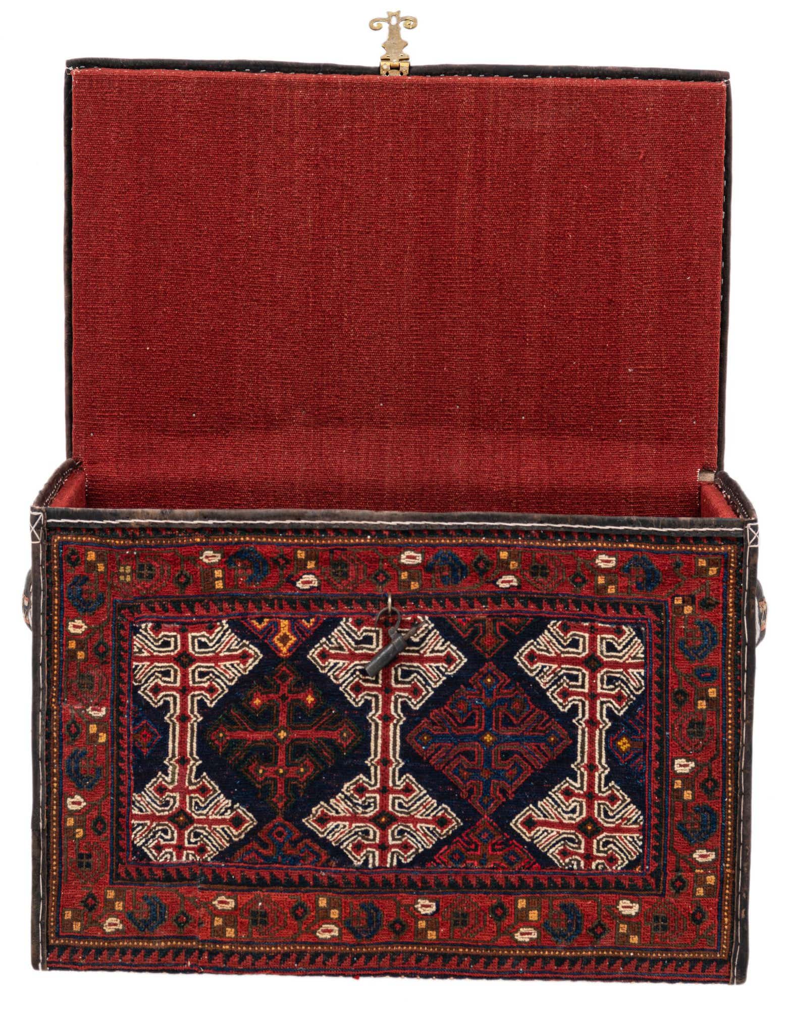 An open rectangular storage box, handmade with a traditional red and navy oriental rug pattern and a solid red fabric lining.