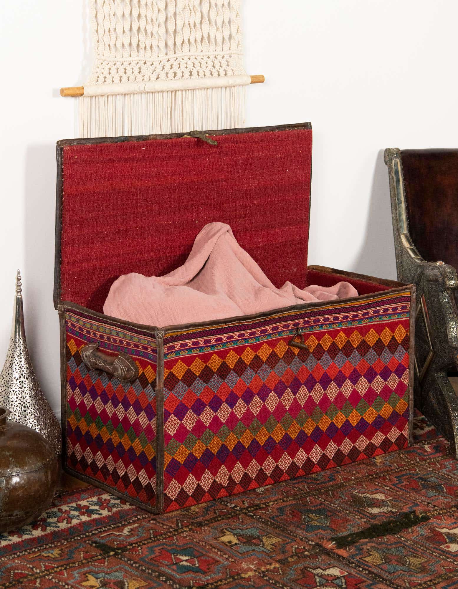 A rectangular 2x3 orange and red traditional rug with an intricate oriental pattern, placed on a wooden floor.