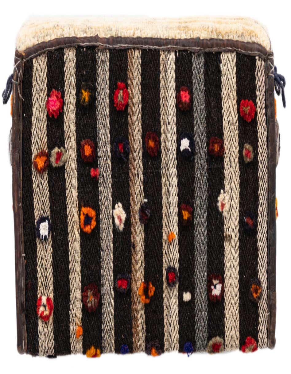 A rectangular 1x2 ivory and black striped rug with colorful textured accents, handmade for indoor use.