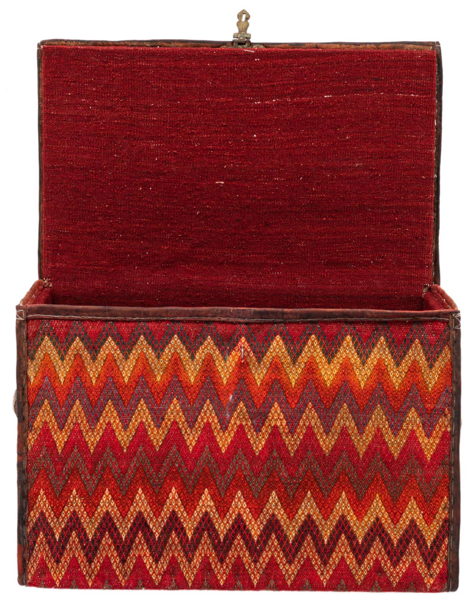 Open rectangular storage chest with a vibrant orange and red zigzag pattern on the exterior and a solid red interior.