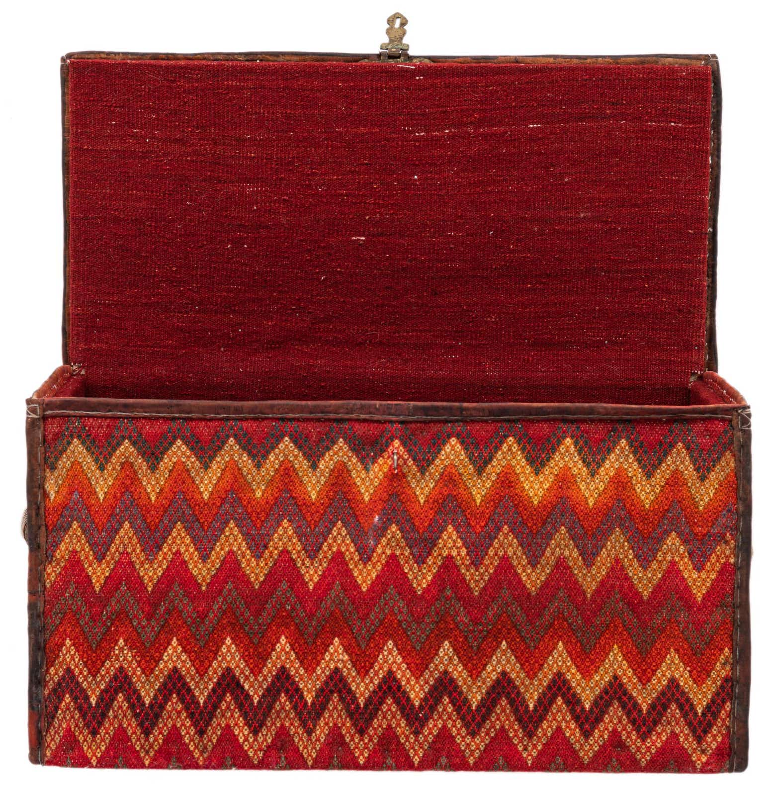 Open rectangular storage chest with a vibrant orange and red zigzag pattern on the exterior and a solid red interior.