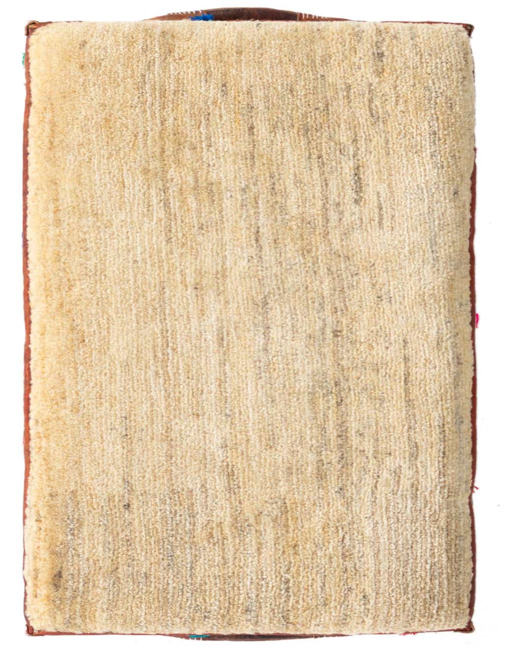 Close-up of a rectangular, handmade brown and ivory rug with a medium pile, showcasing its textured surface.