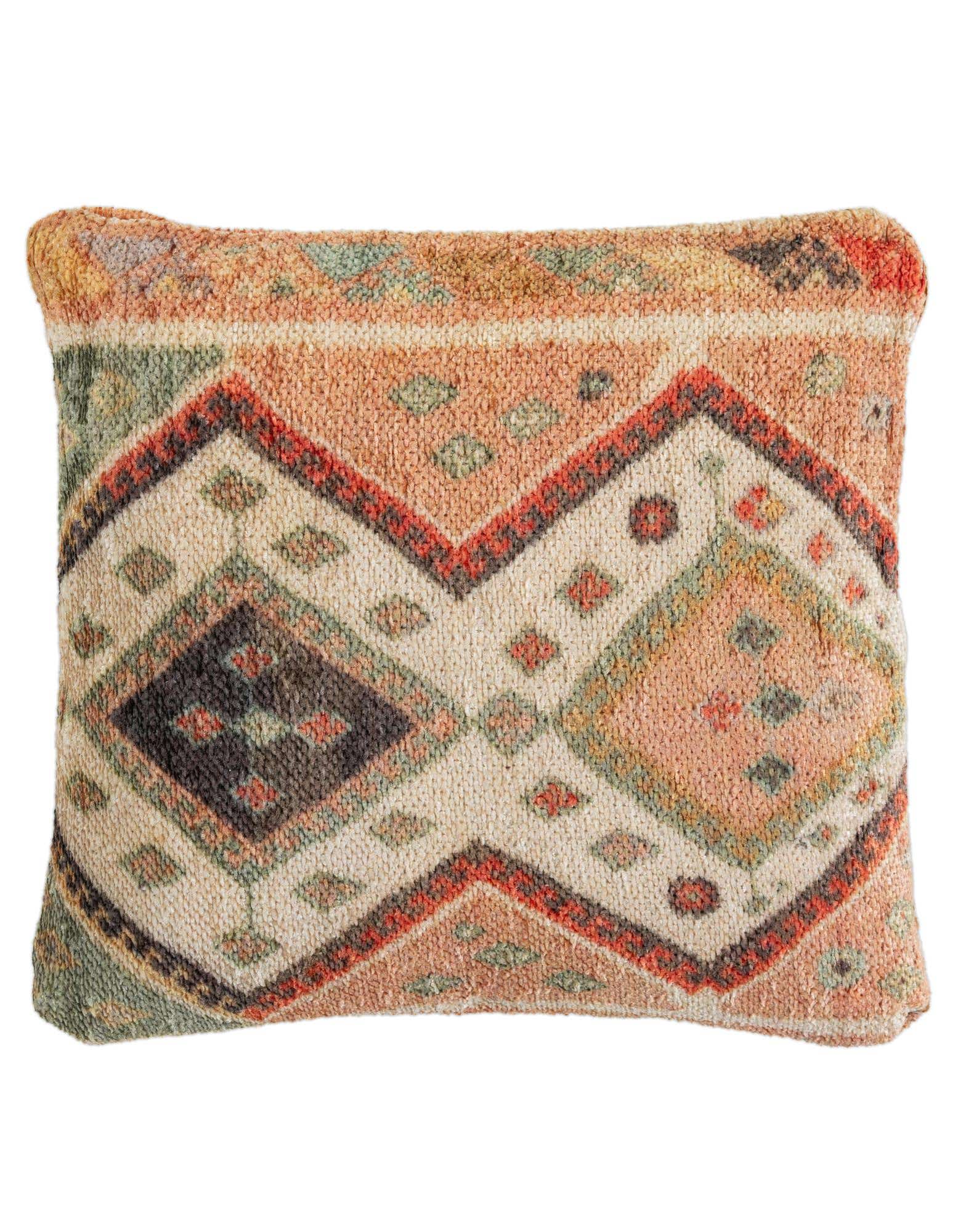 Rectangular multi-colored modern pillow with geometric patterns in peach, green, red, and cream.