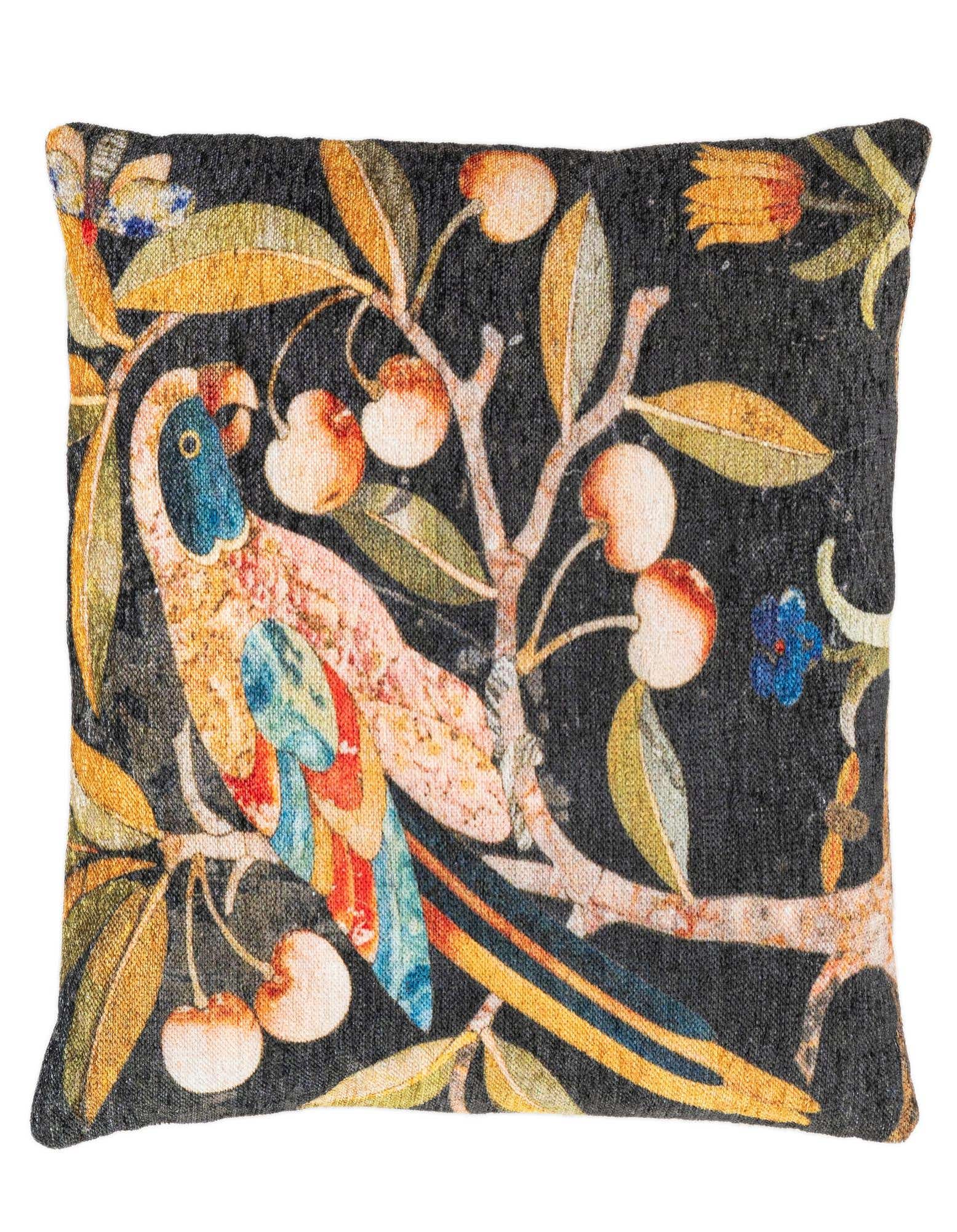A multi-colored rectangular pillow featuring a vibrant parrot perched on a branch with leaves and berries, set against a dark background.