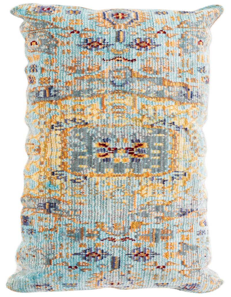 Close-up of a rectangular blue vintage Oriental medallion pillow with orange, yellow, and red accents.