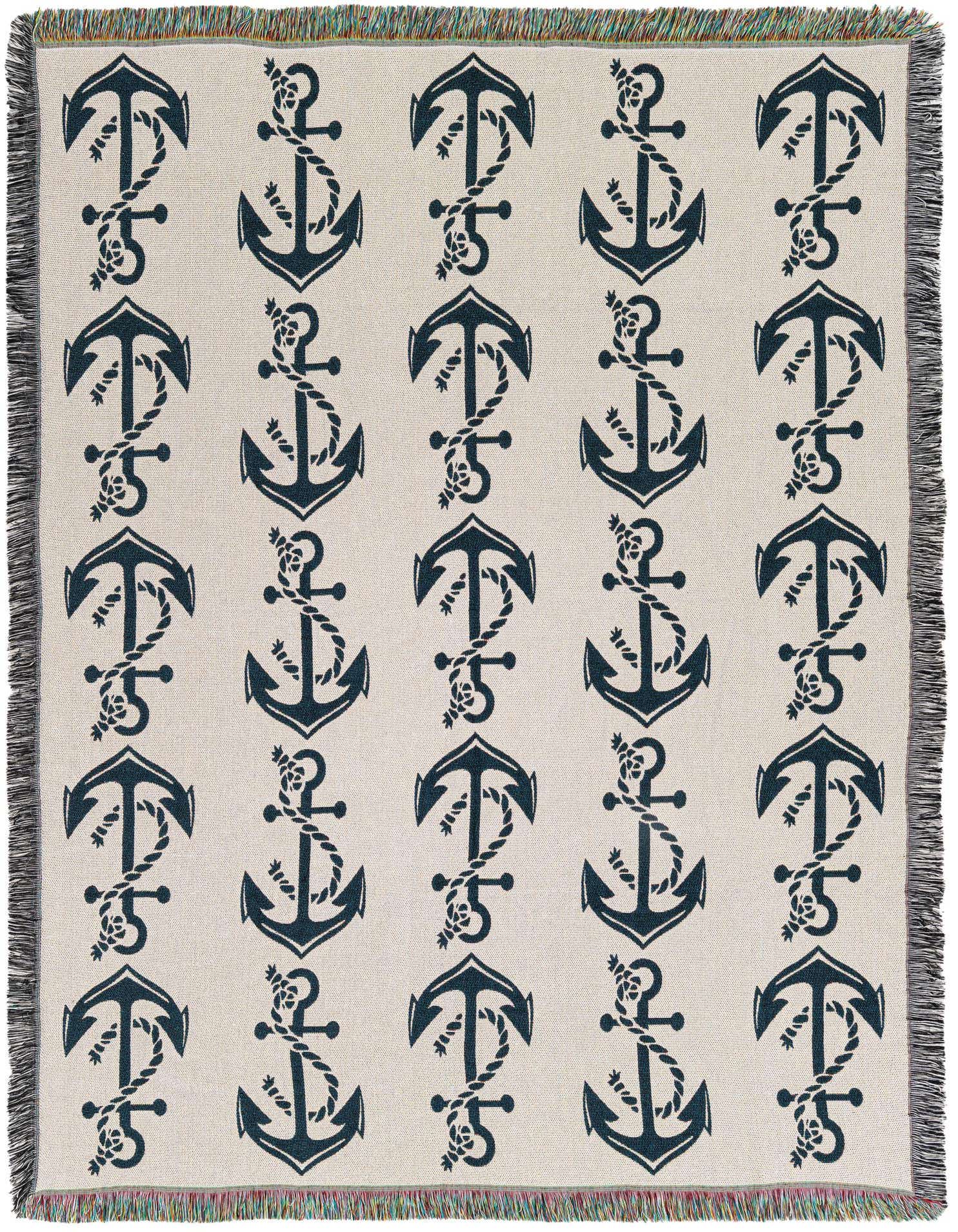A 4x6 rectangular ivory cotton throw blanket with a repeating pattern of dark blue anchors wrapped in rope, featuring fringed edges.