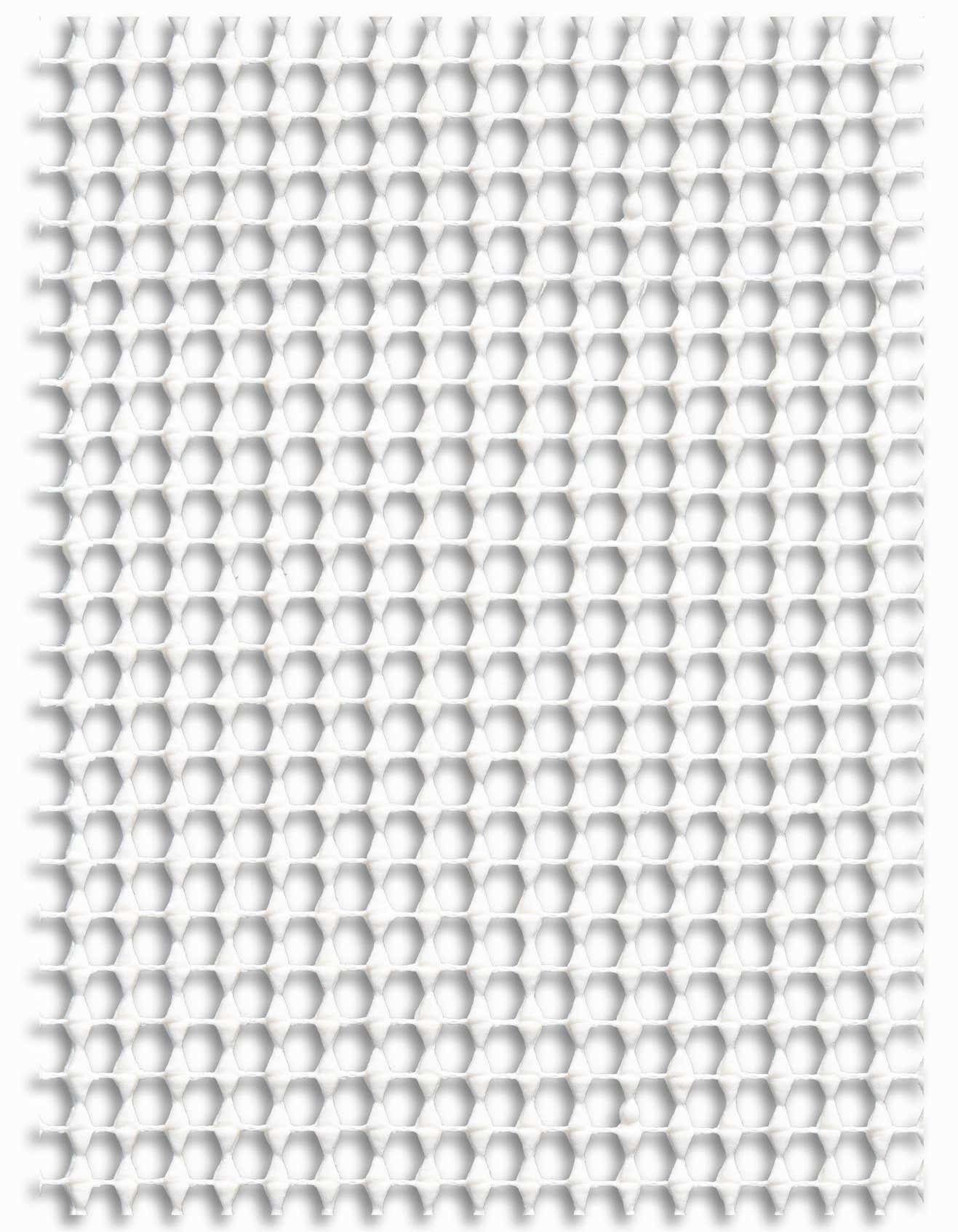 A close-up view of a white rectangular rug pad with a repeating honeycomb or hexagonal pattern, designed for indoor use.