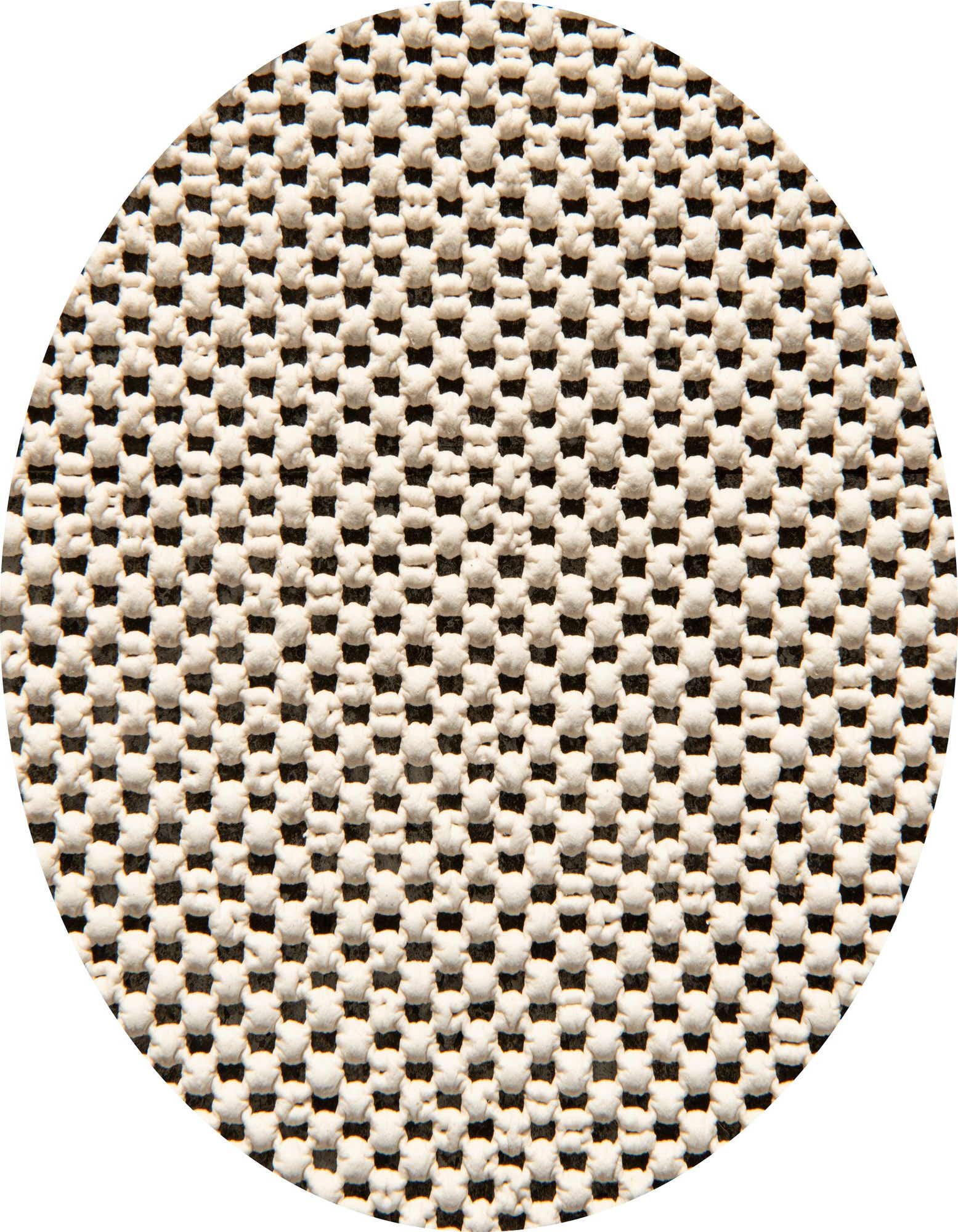 Close-up of a round rug pad with a grid pattern of small, raised white rubber dots on a dark grey background, designed to prevent slipping.