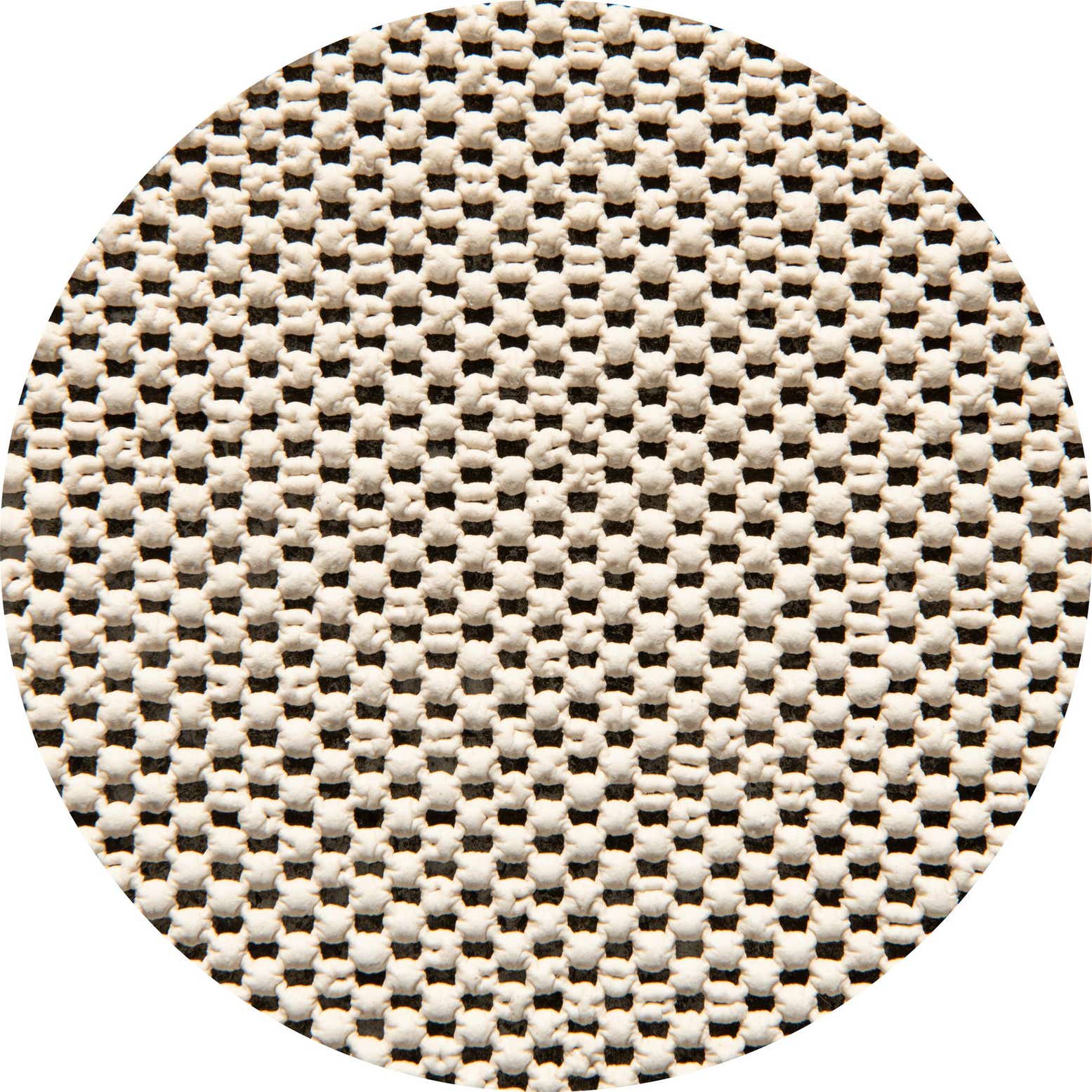 Close-up of a white, textured rug pad with a grid pattern of small, raised rubber dots for non-slip grip.