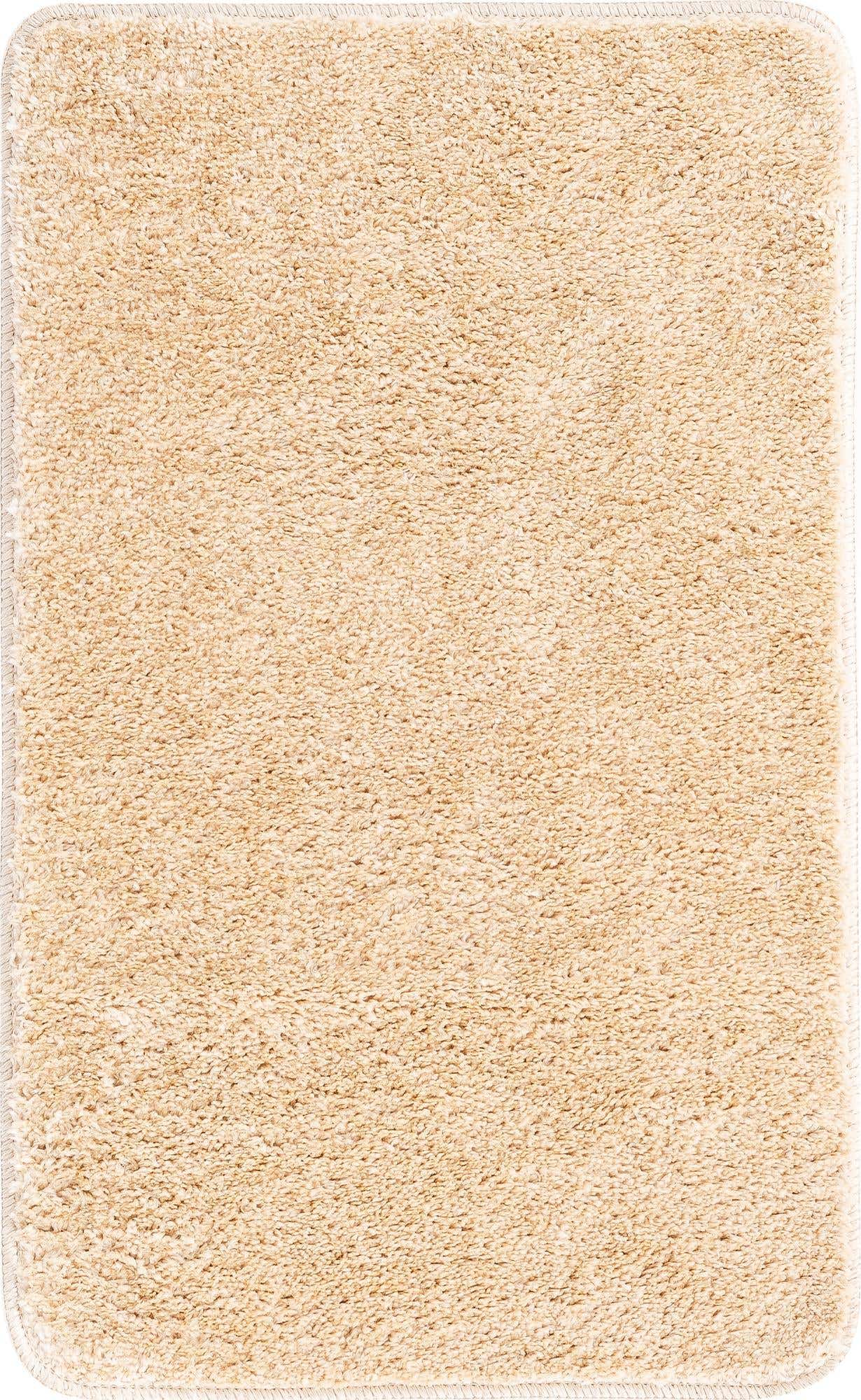 A 2x3 rectangular Bano Everyday Bath Mat from Rugs.com in a solid ivory/cream color with a textured pile, ideal for indoor use.