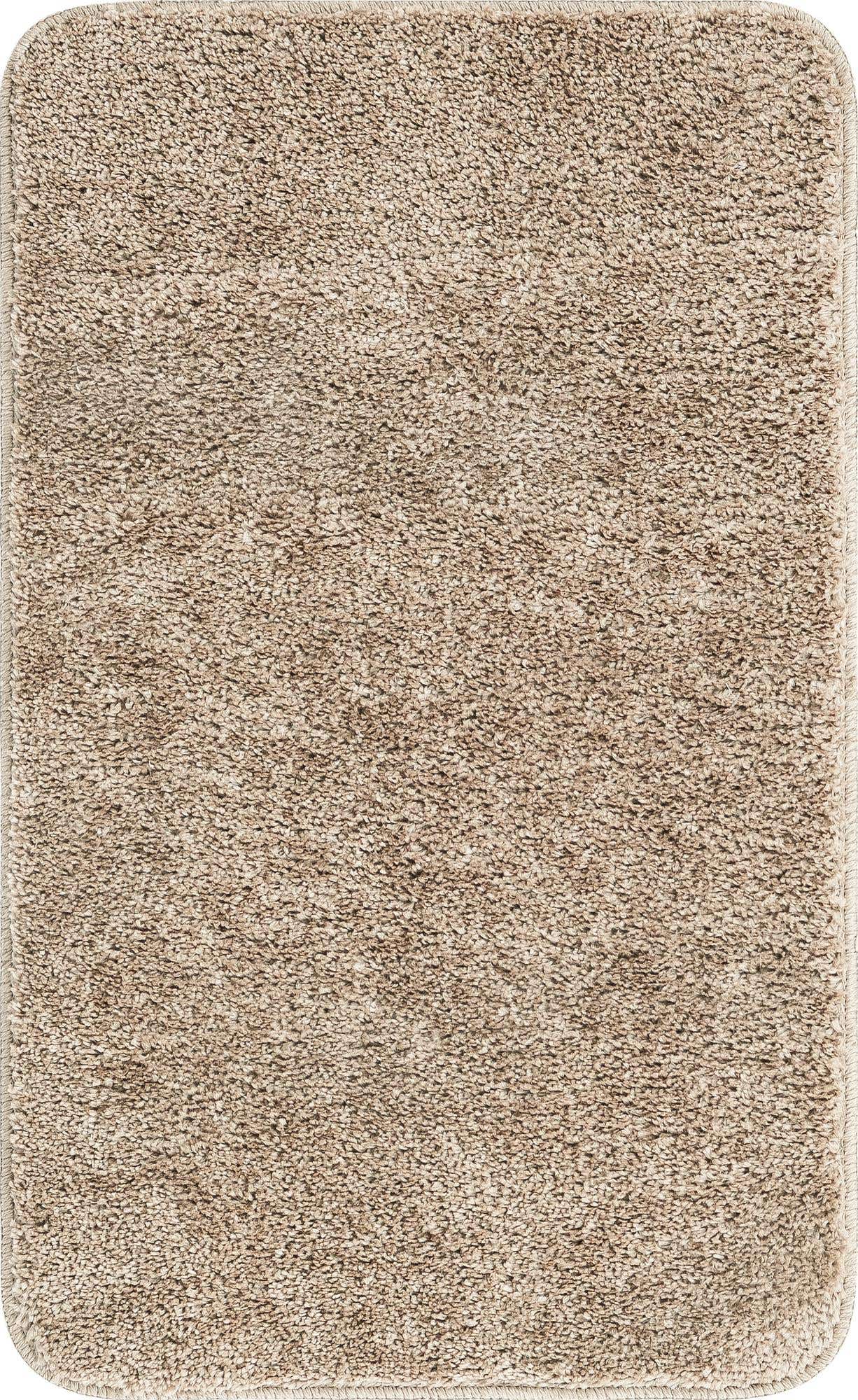 A 2x3 rectangular Bano Everyday Bath Mat from Rugs.com, featuring a textured, solid brown and tan pile with rounded corners.