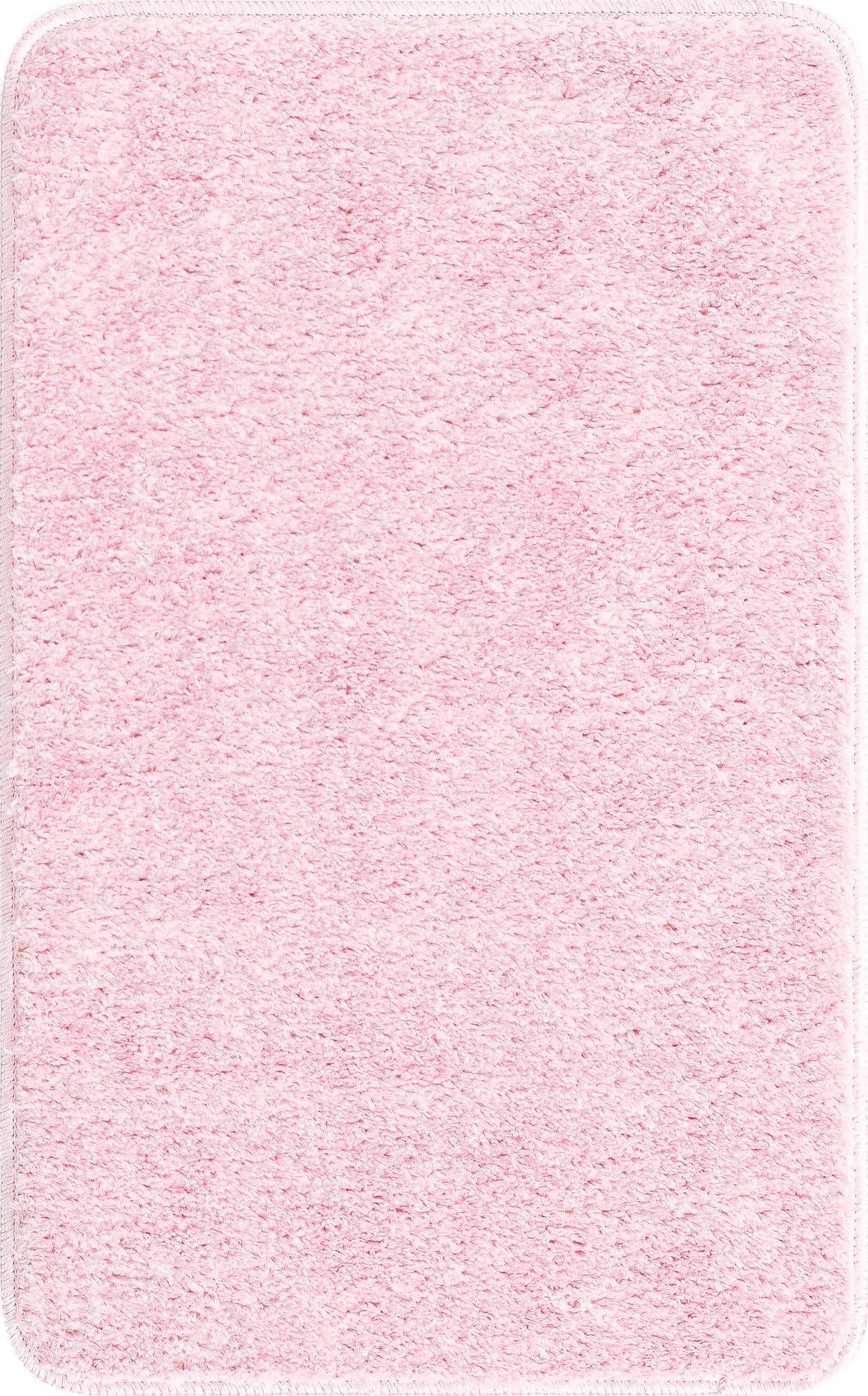 A soft, rectangular 2x3 pink polyester bath mat with a textured pile and non-slip backing.