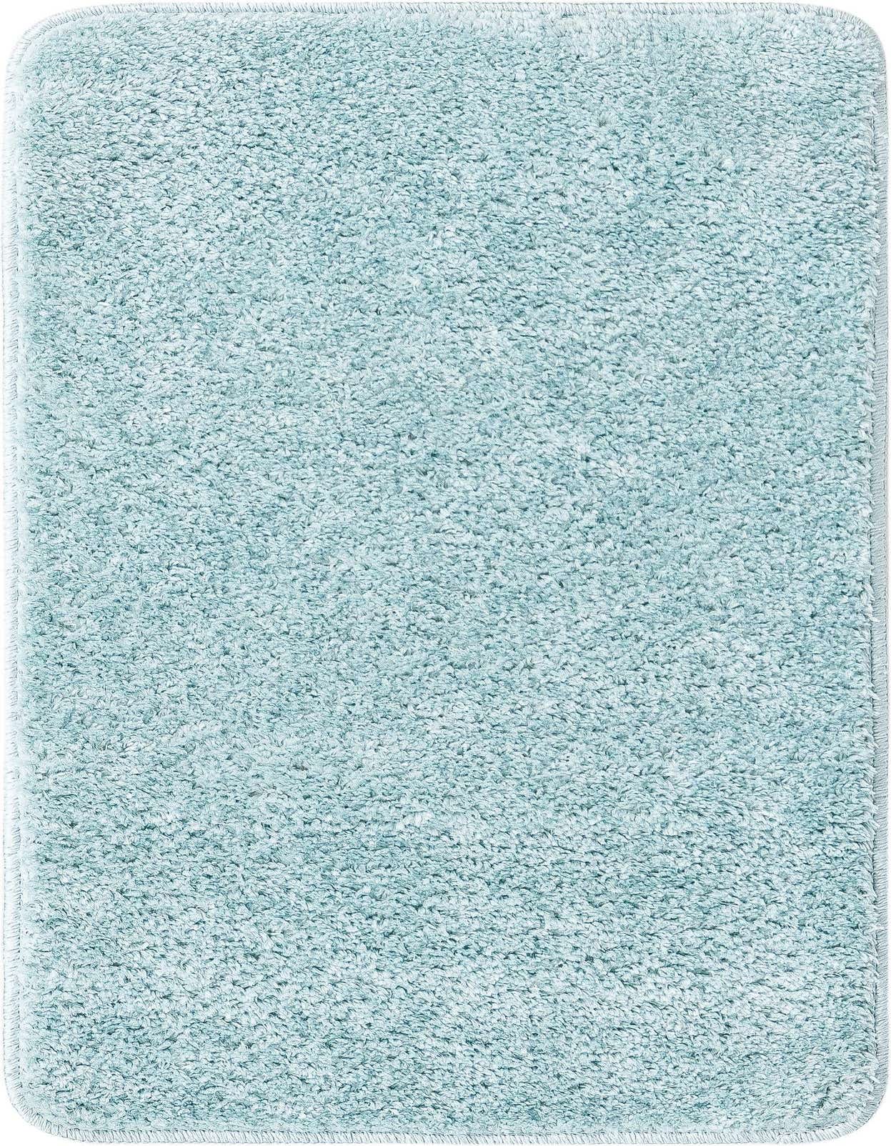 A 2x3 rectangular Bano Everyday Bath Mat in a solid light blue color with a textured pile, suitable for indoor use.