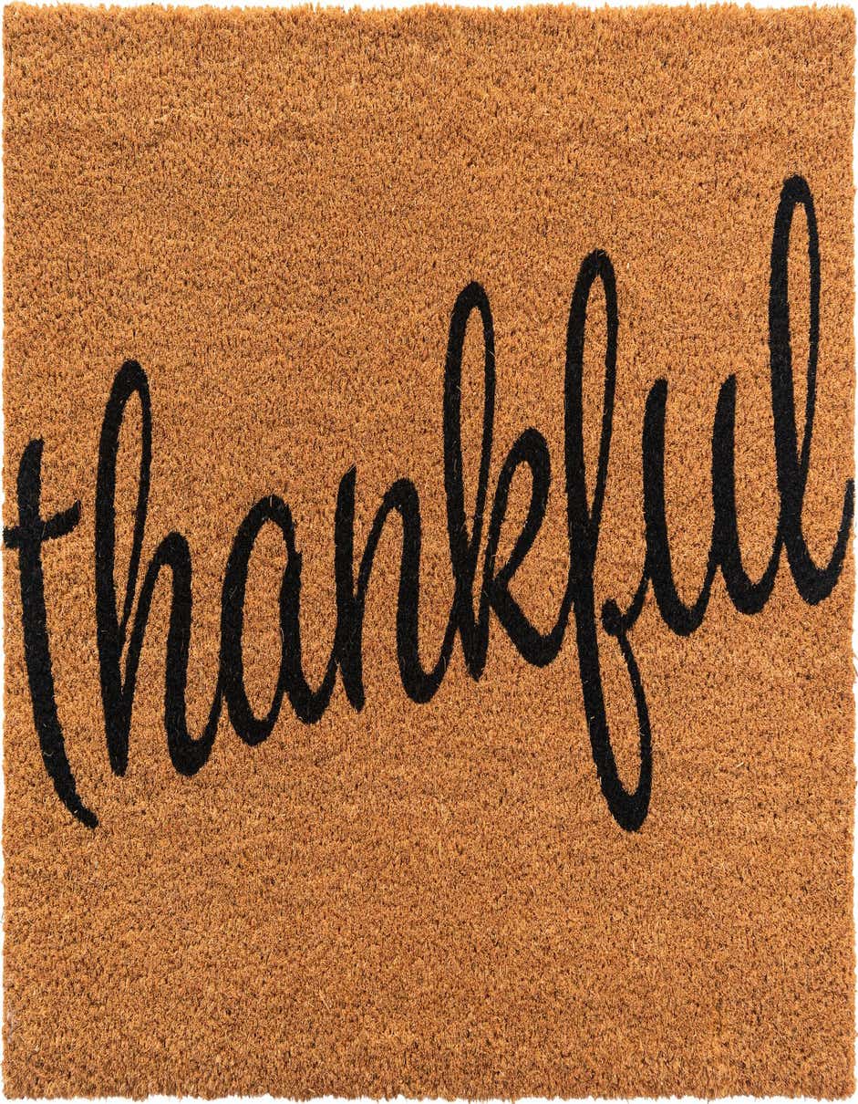 A rectangular 2x3 brown coir doormat with the word "thankful" in black script across the center.
