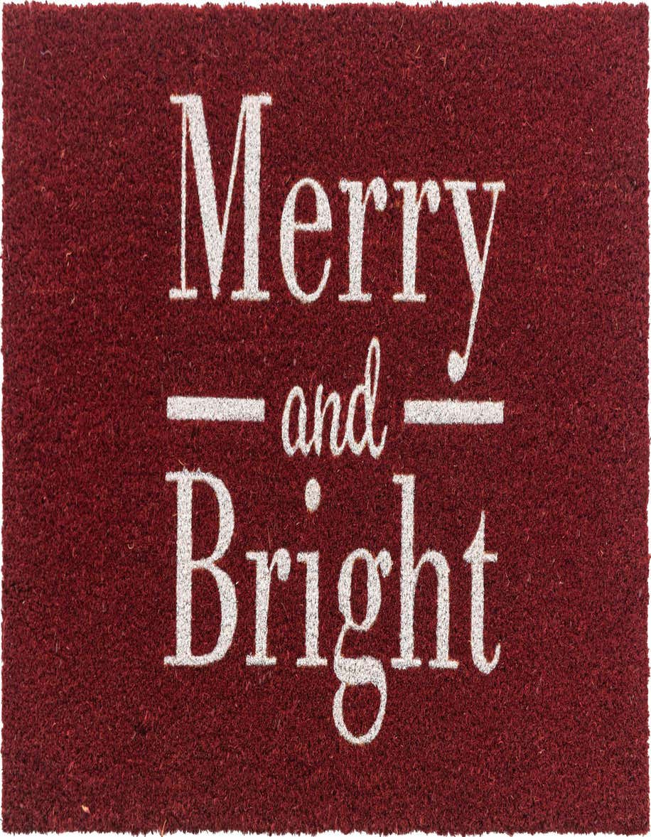 A rectangular red coir doormat with "Merry and Bright" in white text, perfect for indoor holiday decor.