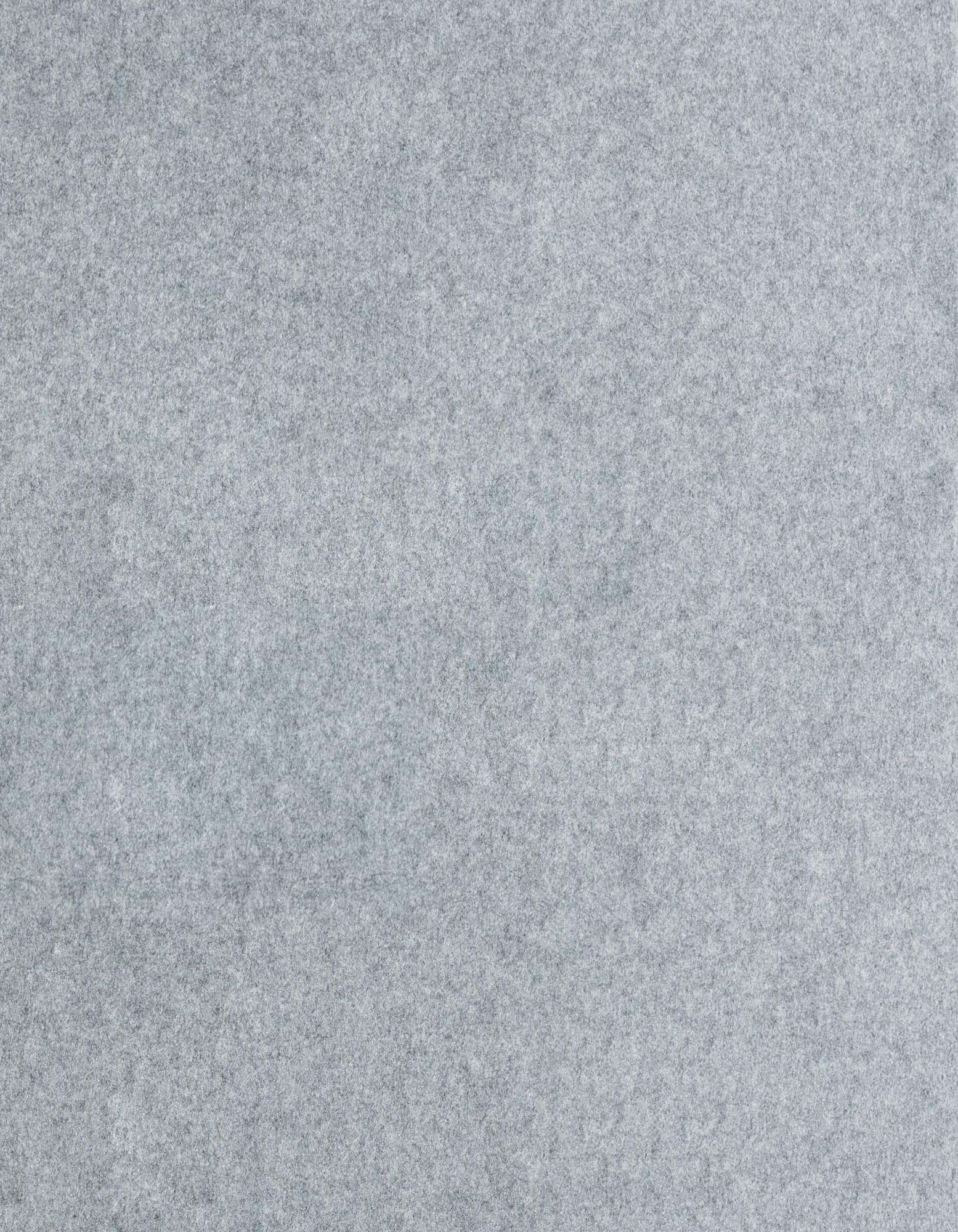 A close-up view of a medium pile, light gray square rug pad, showing its soft, textured surface.