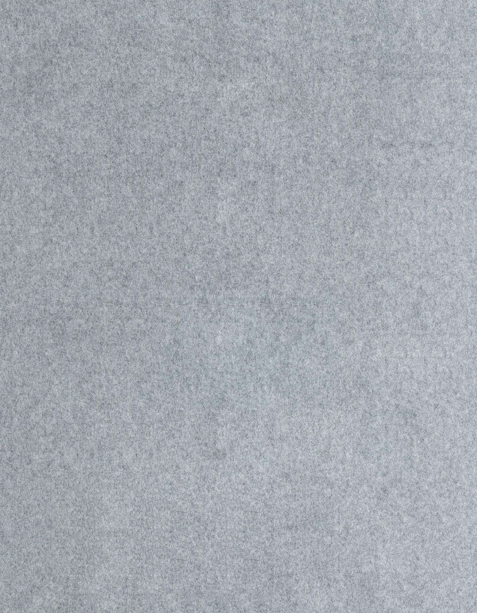 A close-up view of a medium gray, textured rug pad, showing its dense, felt-like surface.