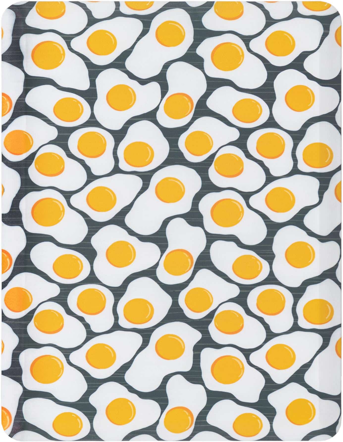 A rectangular 2x3 black rug with a playful pattern of white fried eggs with bright yellow yolks, ideal for a kitchen.