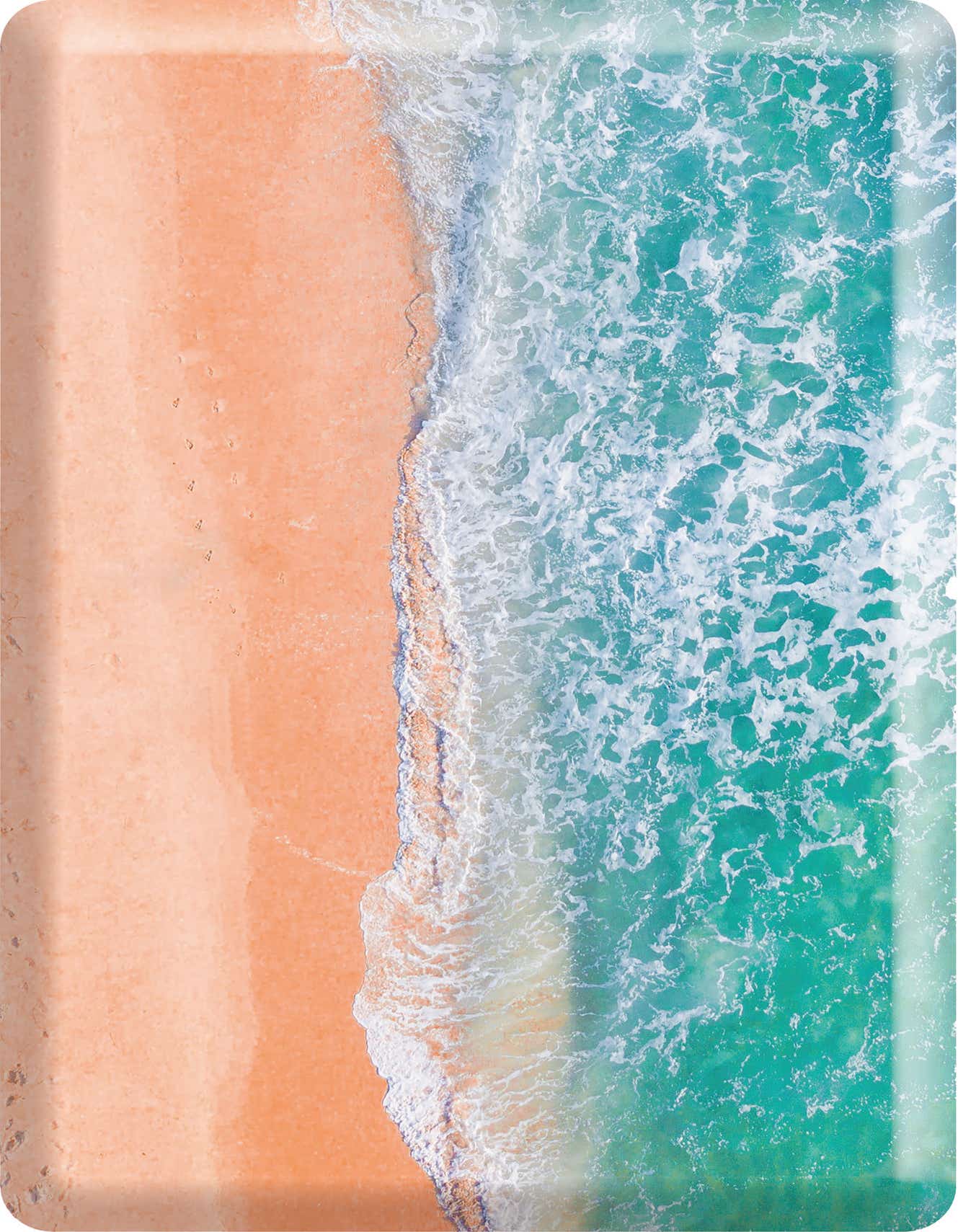 Aerial view of a beach with light orange sand meeting vibrant turquoise ocean water with white foamy waves.