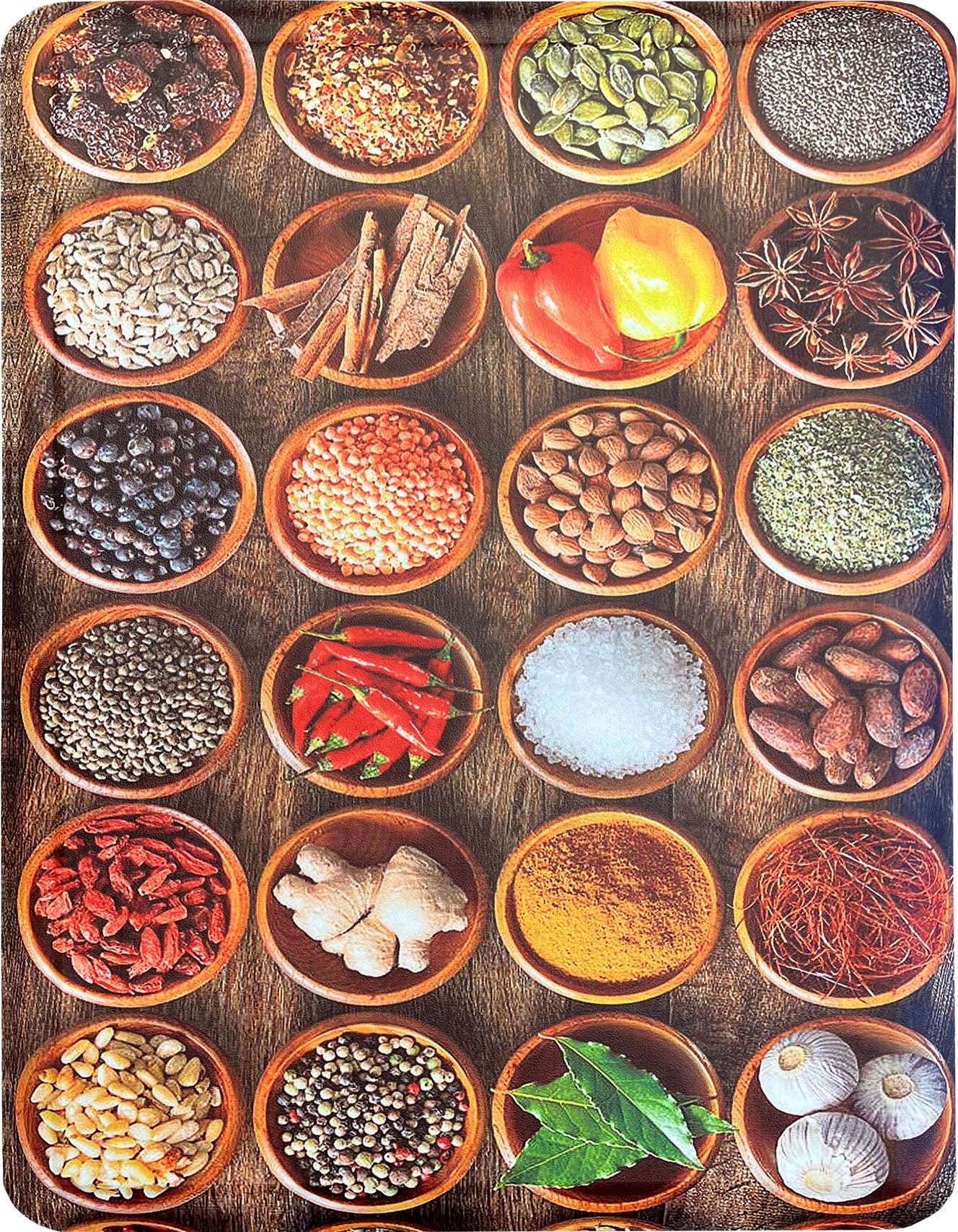 A rectangular 2x3 multi-colored Comfort Mat rug with a vibrant pattern of various spices and ingredients in wooden bowls on a dark wood background.