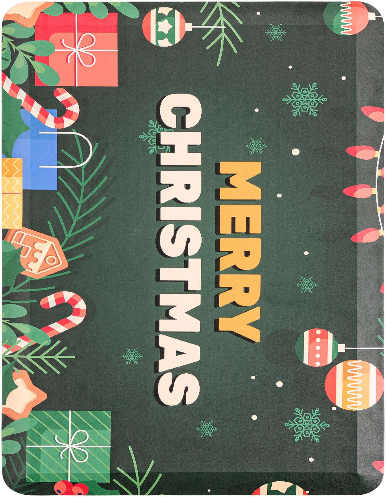A rectangular green Christmas comfort mat with 'Merry Christmas' text, gifts, candy canes, ornaments, and snowflakes.