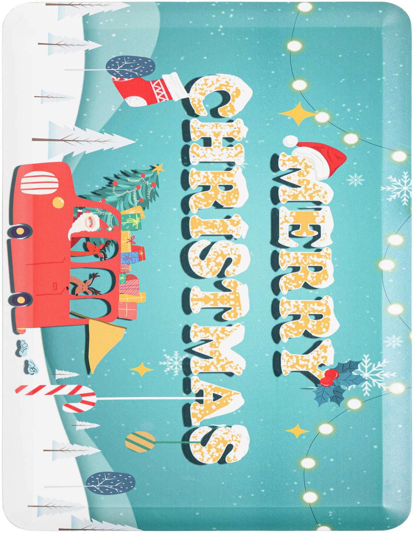A festive rectangular rug featuring a red truck carrying a Christmas tree and gifts, with 'Merry Christmas' text, snowflakes, and string lights on a blue background.