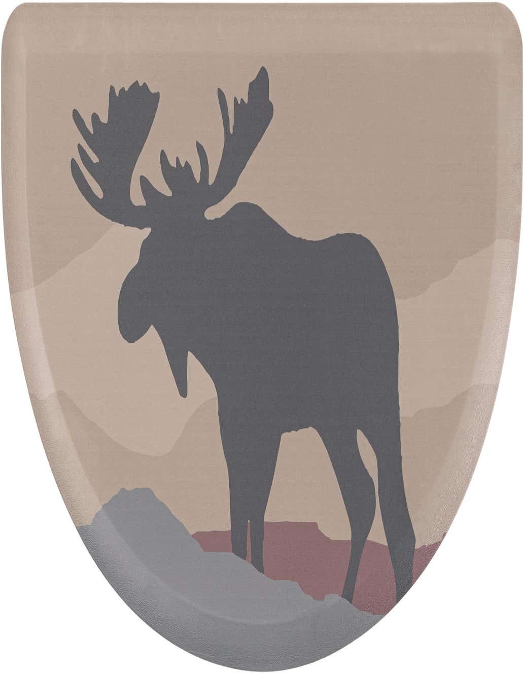 A hearth-shaped comfort mat featuring a dark gray moose silhouette against a multi-colored, layered landscape in muted tones.