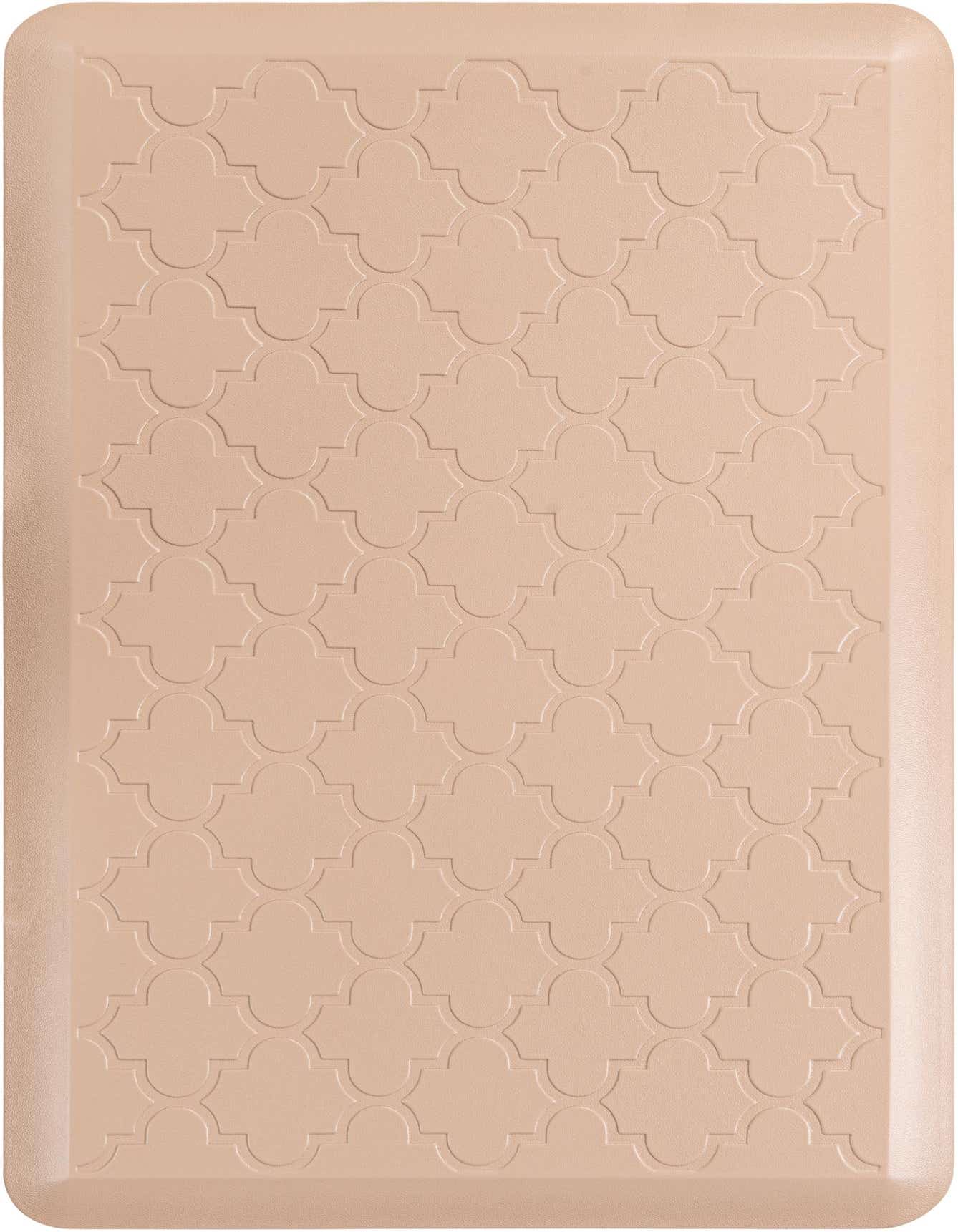 A 2x3 rectangular Comfort Mat by Rugs.com in a light brown or tan color, featuring an embossed quatrefoil pattern.