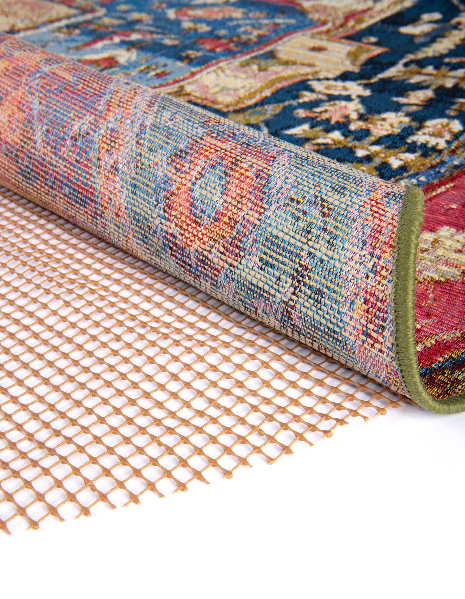 A close-up of a brown grid-patterned round rug pad, showing its textured, open weave for indoor/outdoor use.