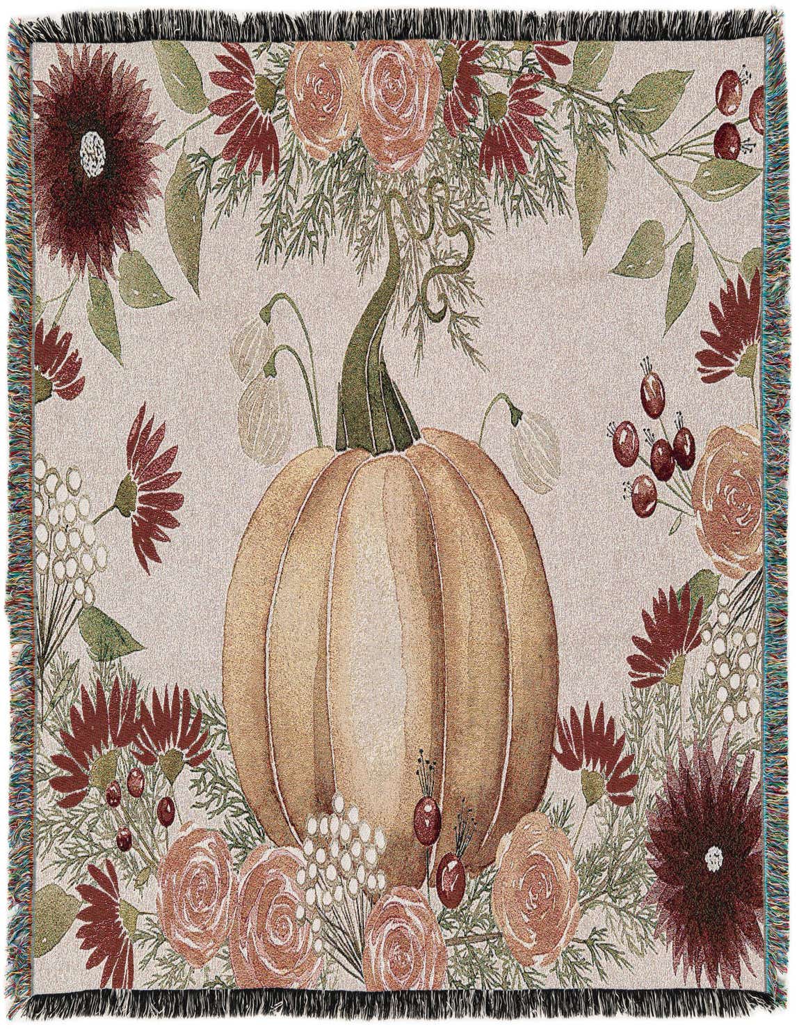 A rectangular 4x6 throw blanket featuring a large central orange pumpkin surrounded by a border of autumn flowers and berries on a light background, with fringed edges.