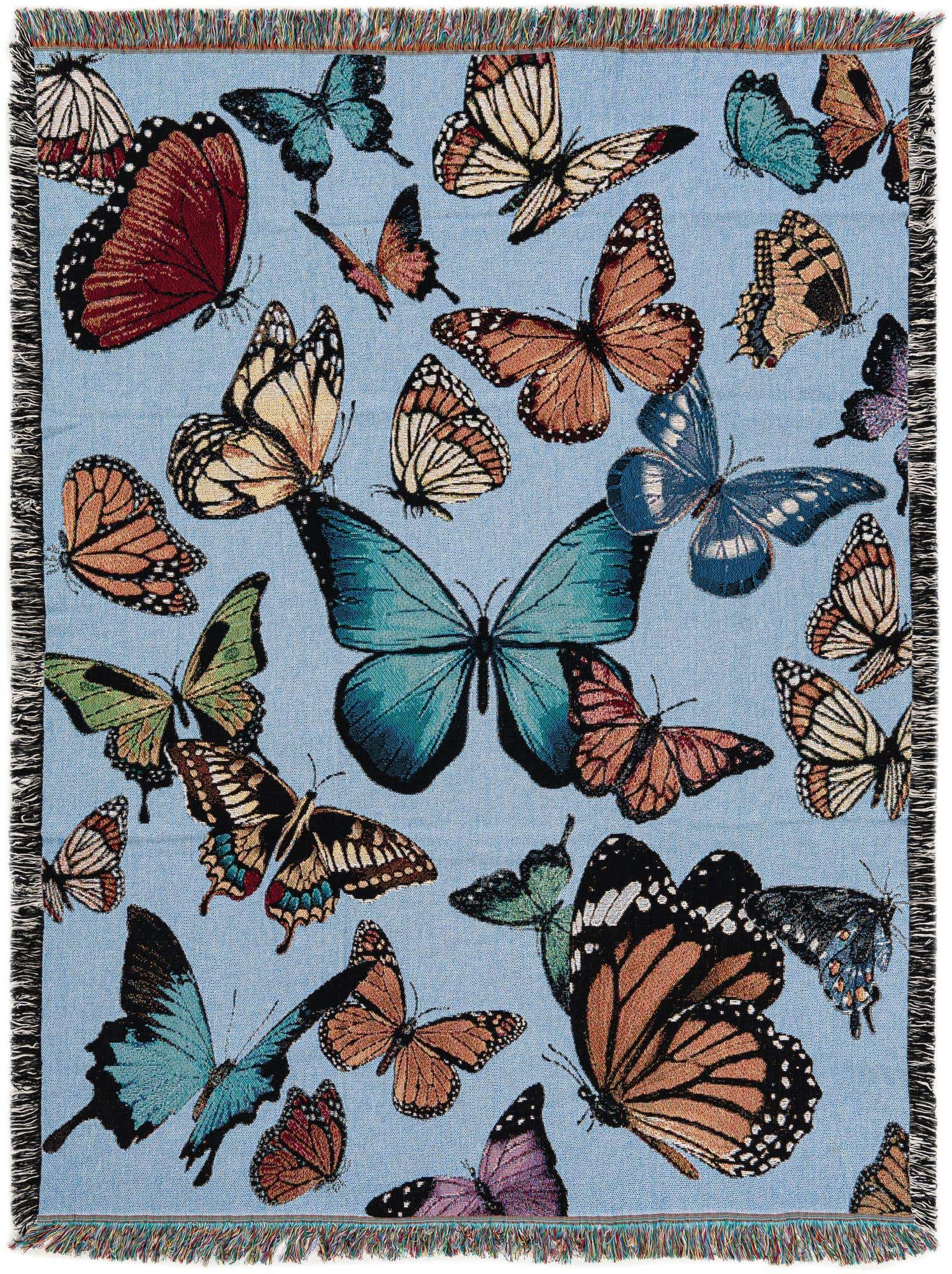 A rectangular 4x6 multi-colored cotton rug with a vibrant modern butterfly pattern on a light blue background, featuring fringe edges.