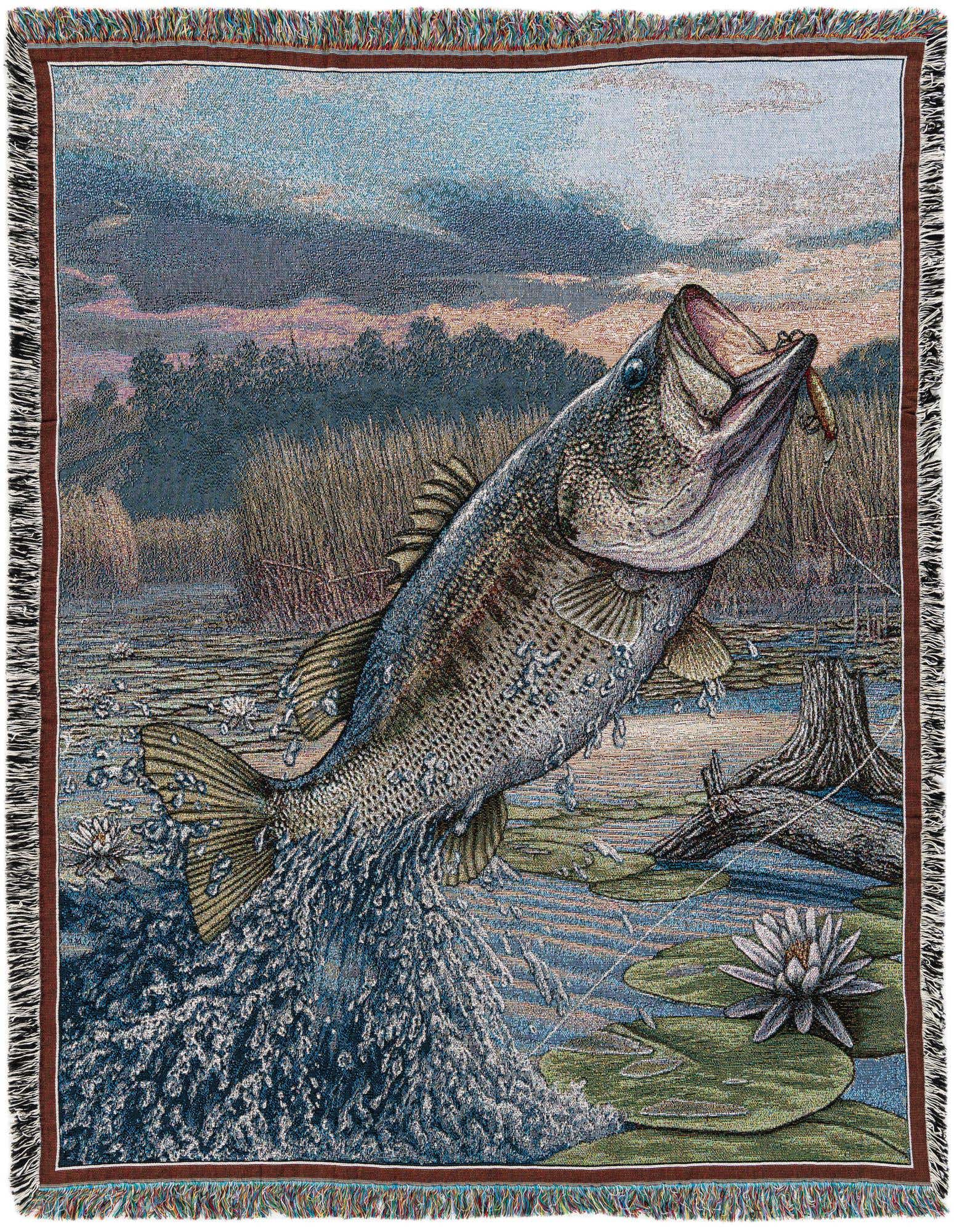 A multi-colored rectangular throw blanket depicting a large bass fish jumping out of water with a lure in its mouth, surrounded by lily pads and reeds under a dramatic sky.