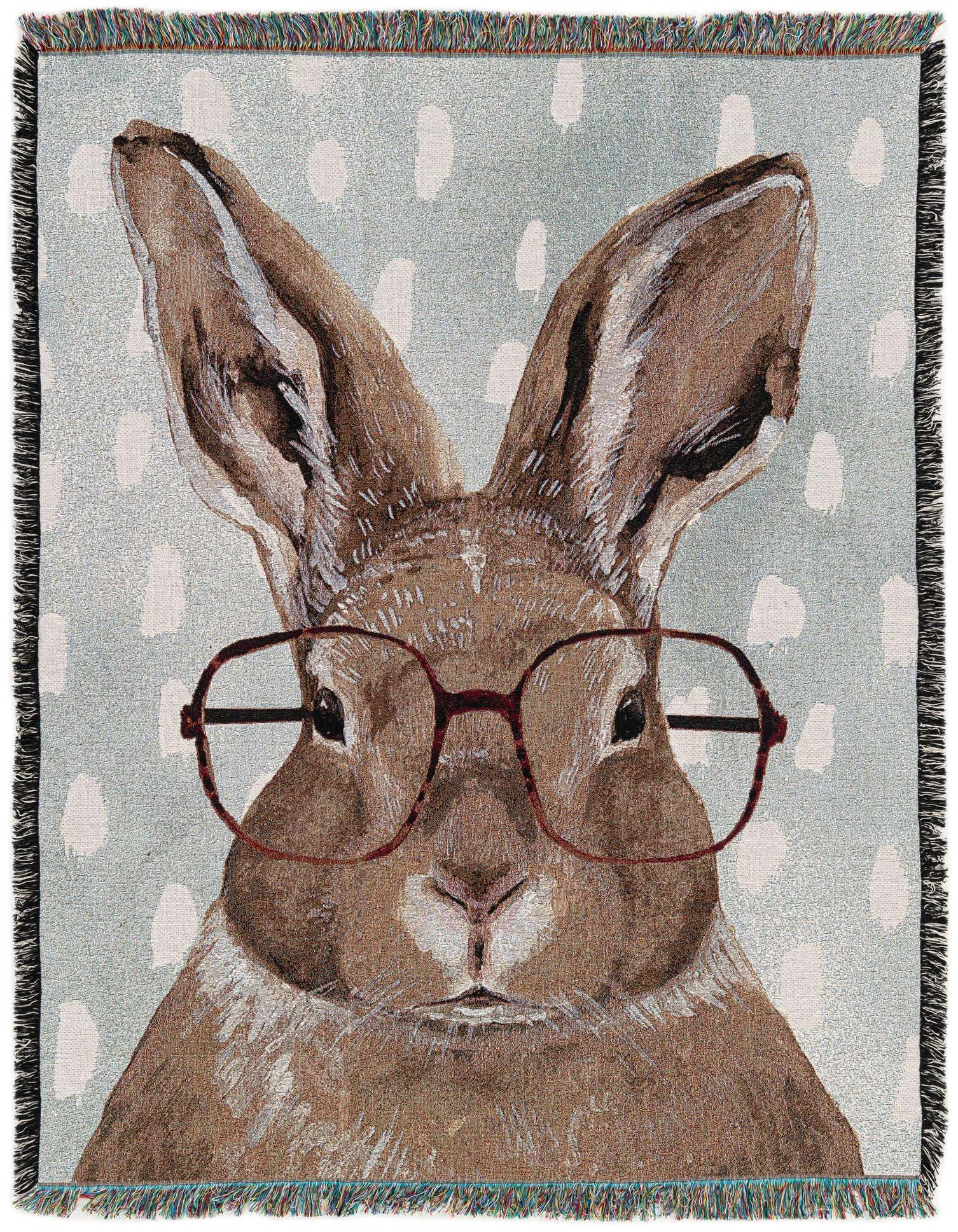 A 4x6 rectangular throw blanket featuring a brown rabbit wearing glasses on a light blue background with white polka dots.