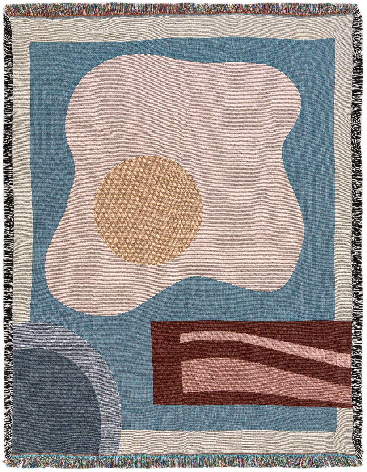 A 4x6 multi-colored modern abstract rug with a light pink blob, an orange circle, and a brown rectangle on a blue background, featuring fringe.