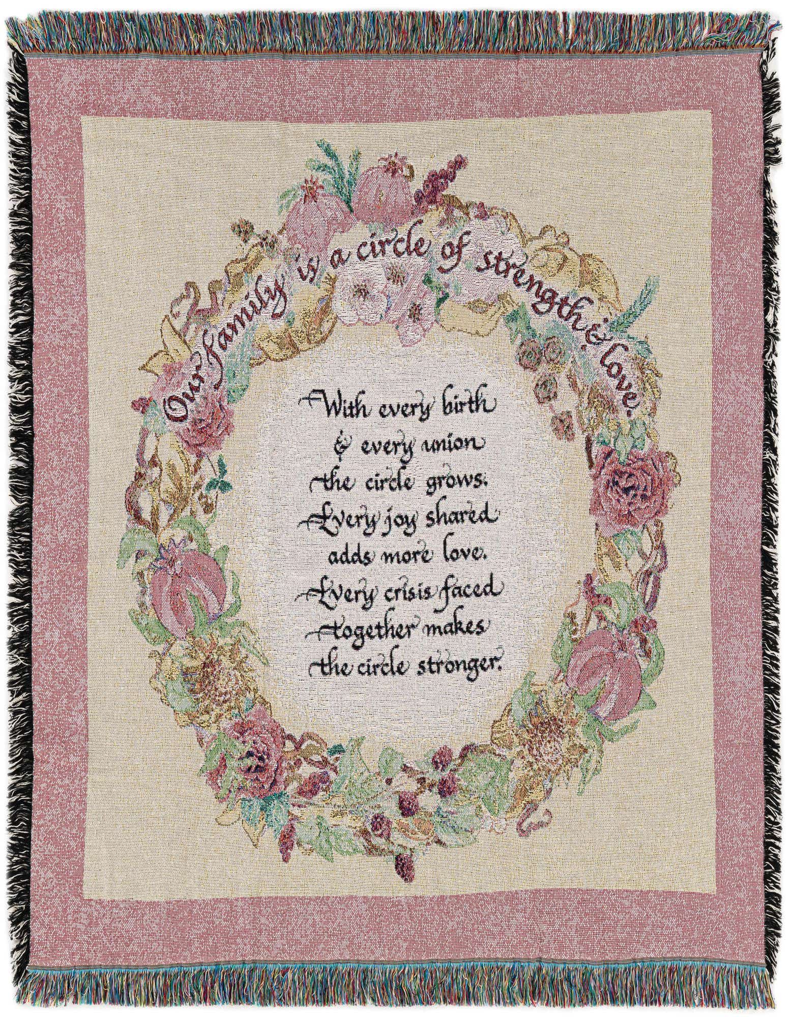 A square, multi-colored cotton throw blanket with fringe, featuring a floral wreath design and a family-themed quote.
