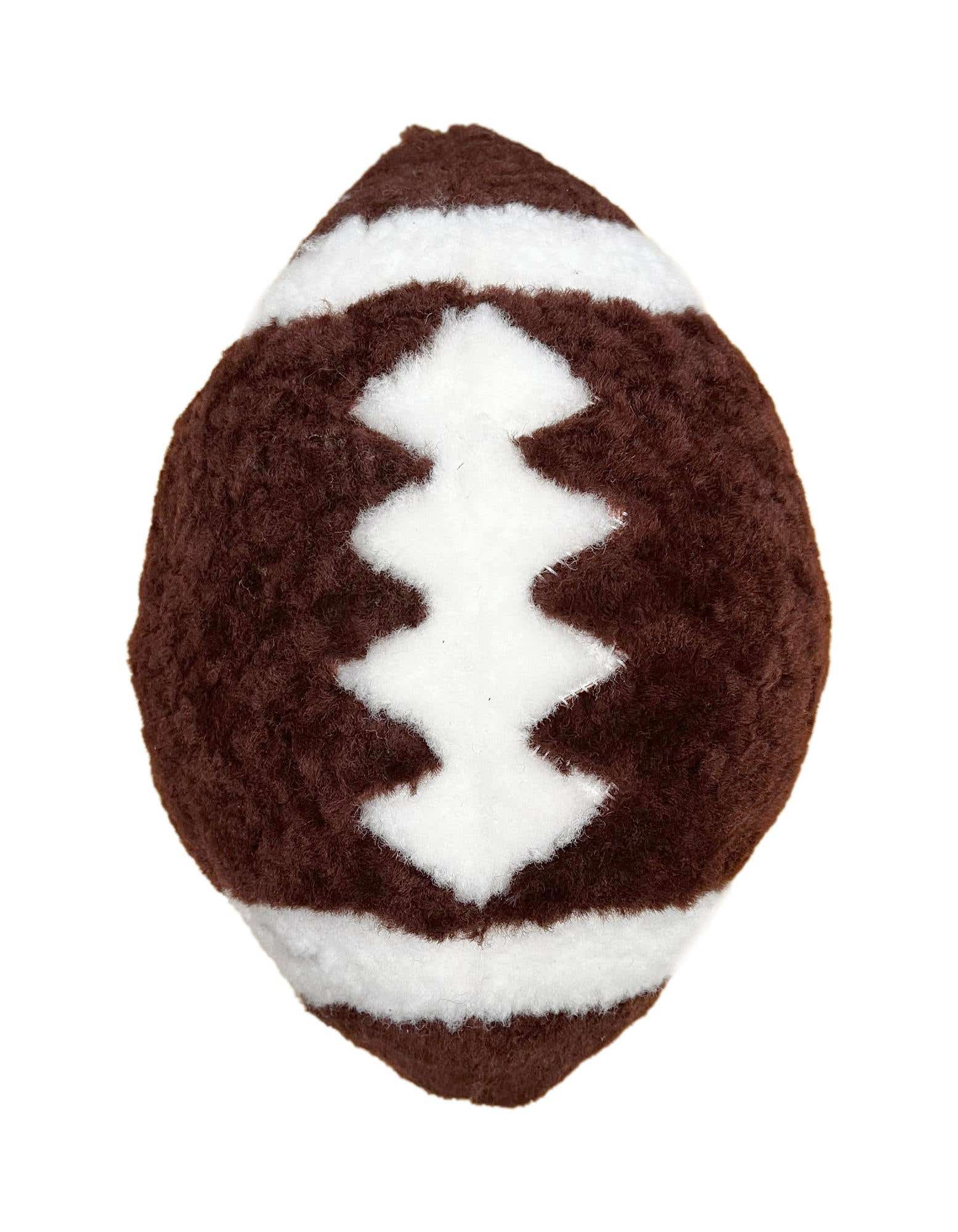 A brown lambskin euro pillow shaped like a football with white stripes and laces, suitable for a patio.