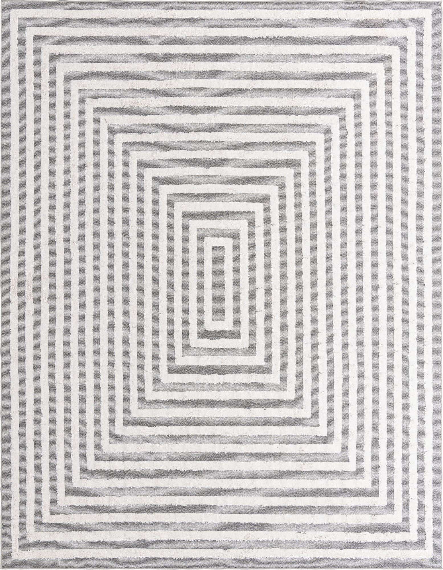 A 9x12 rectangular Sabrina Soto Casa rug features a modern concentric square pattern in black and white, with a textured flatweave.