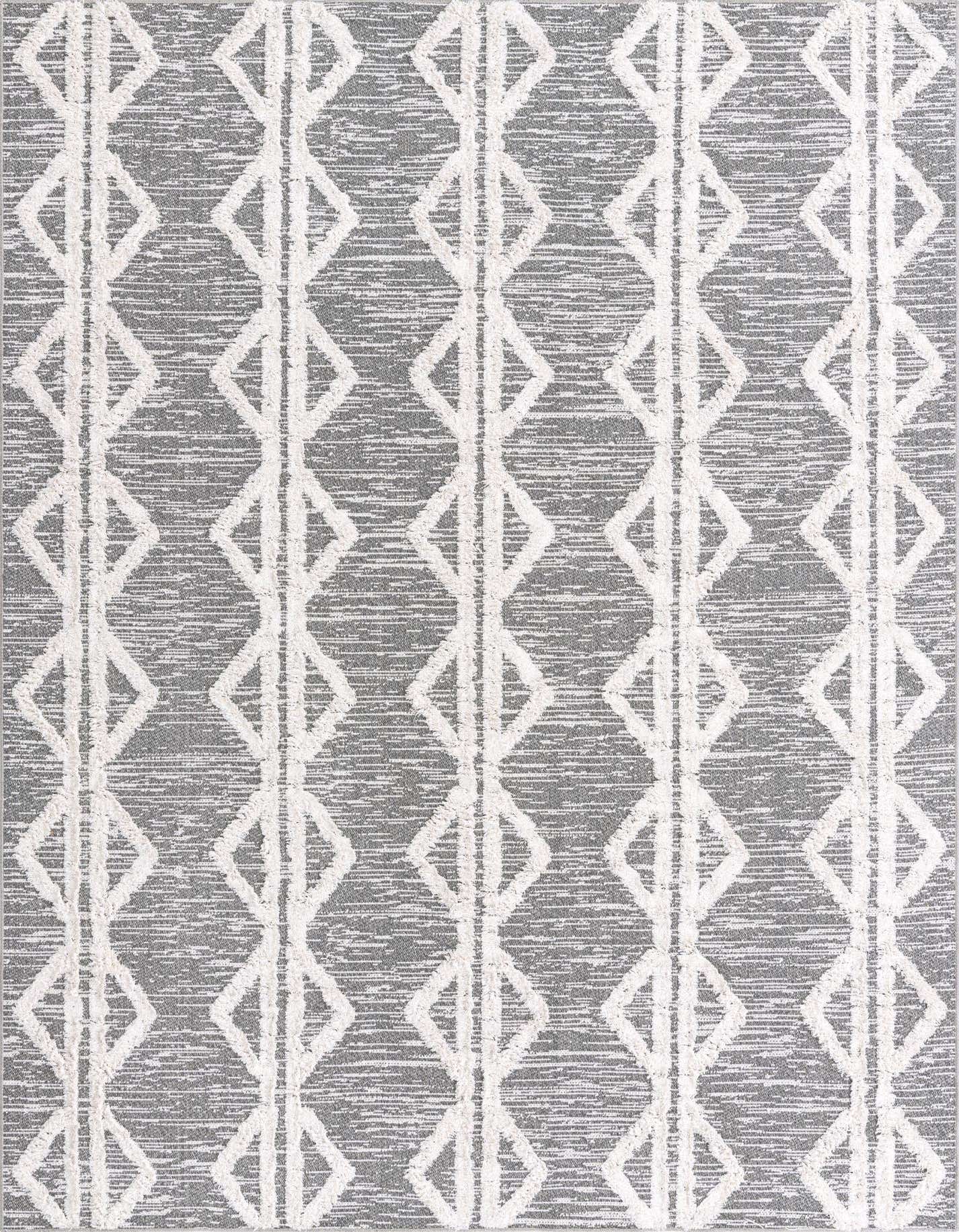 A 6x9 rectangular Sabrina Soto Casa rug featuring a modern tribal stripe pattern in black and gray with textured white diamond motifs.