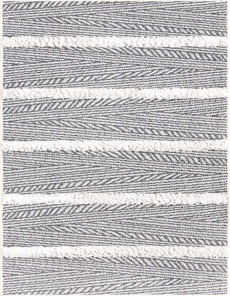 A close-up of a black and white striped runner rug with a modern, textured pattern and high pile details.