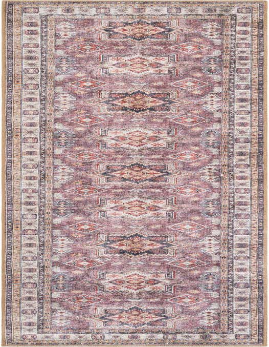 A 10 ft runner rug in antique rose pink with a distressed traditional geometric pattern and decorative border.