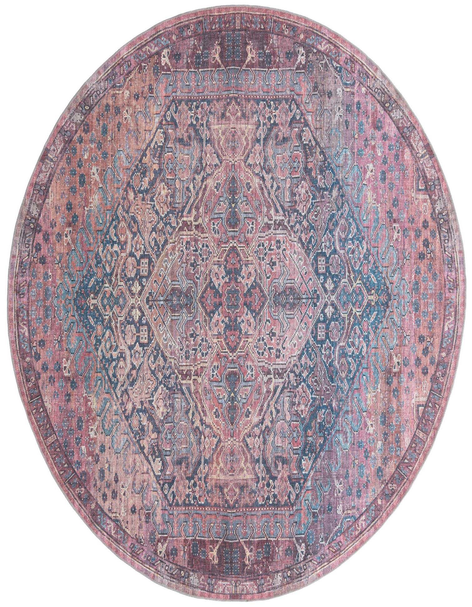 A large round Maahru rug in shades of red, pink, and blue, featuring a distressed traditional floral pattern.