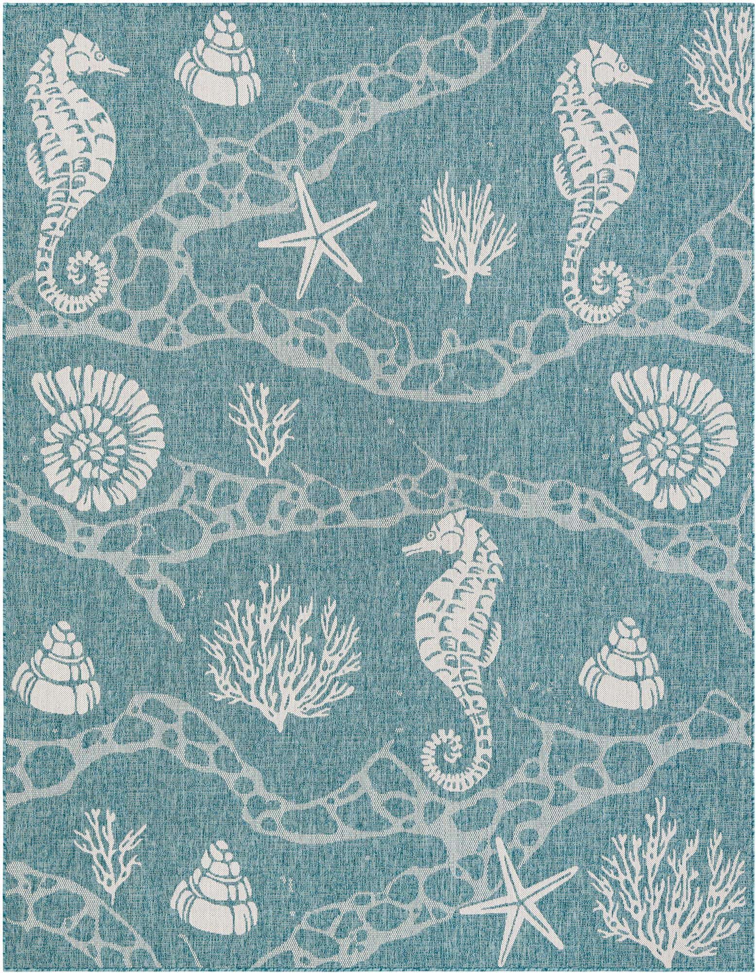 An 8x10 rectangular blue rug with a white coastal pattern featuring seahorses, starfish, seashells, and coral.