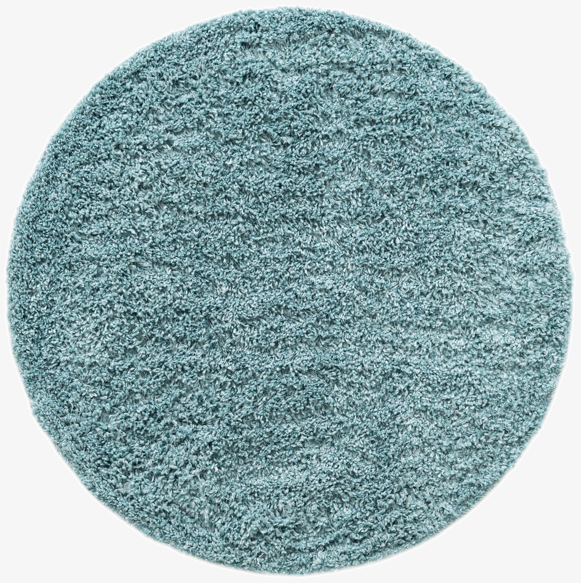 A soft, plush Zermatt Shag round rug in a calming blue color, ideal for adding comfort to any indoor space.
