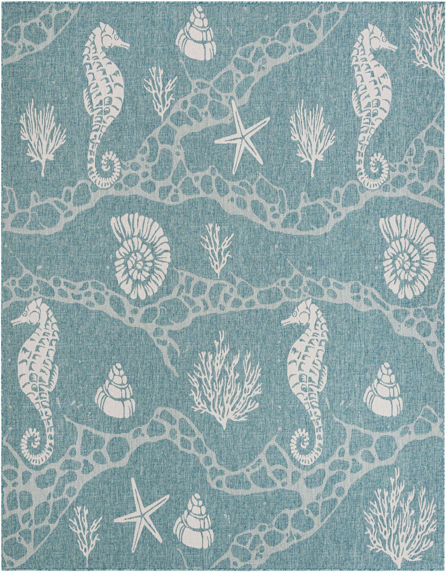 A square blue indoor/outdoor rug with a white beach and nautical pattern featuring seahorses, starfish, coral, and shells.