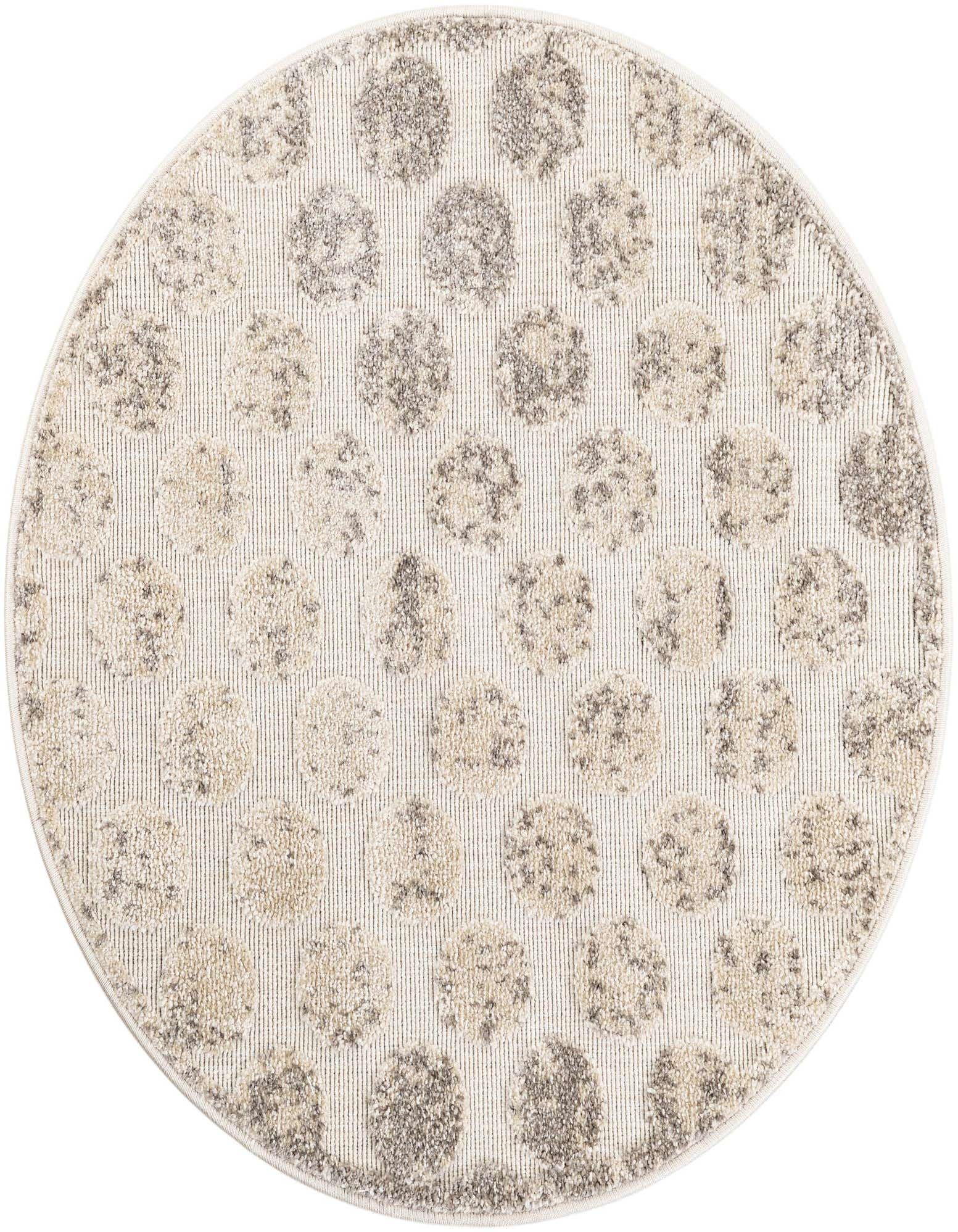 A round ivory and cream rug with a modern polka dot pattern, suitable for indoor or outdoor use.