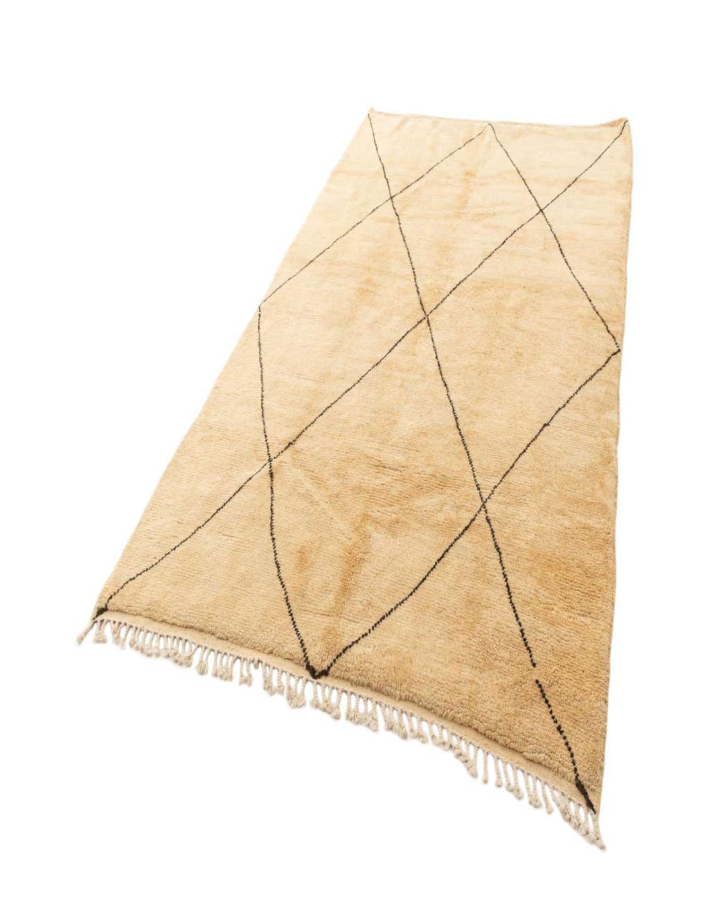 A 6x9 rectangular Berber rug in warm brown and cream tones with a black diamond pattern and fringe.