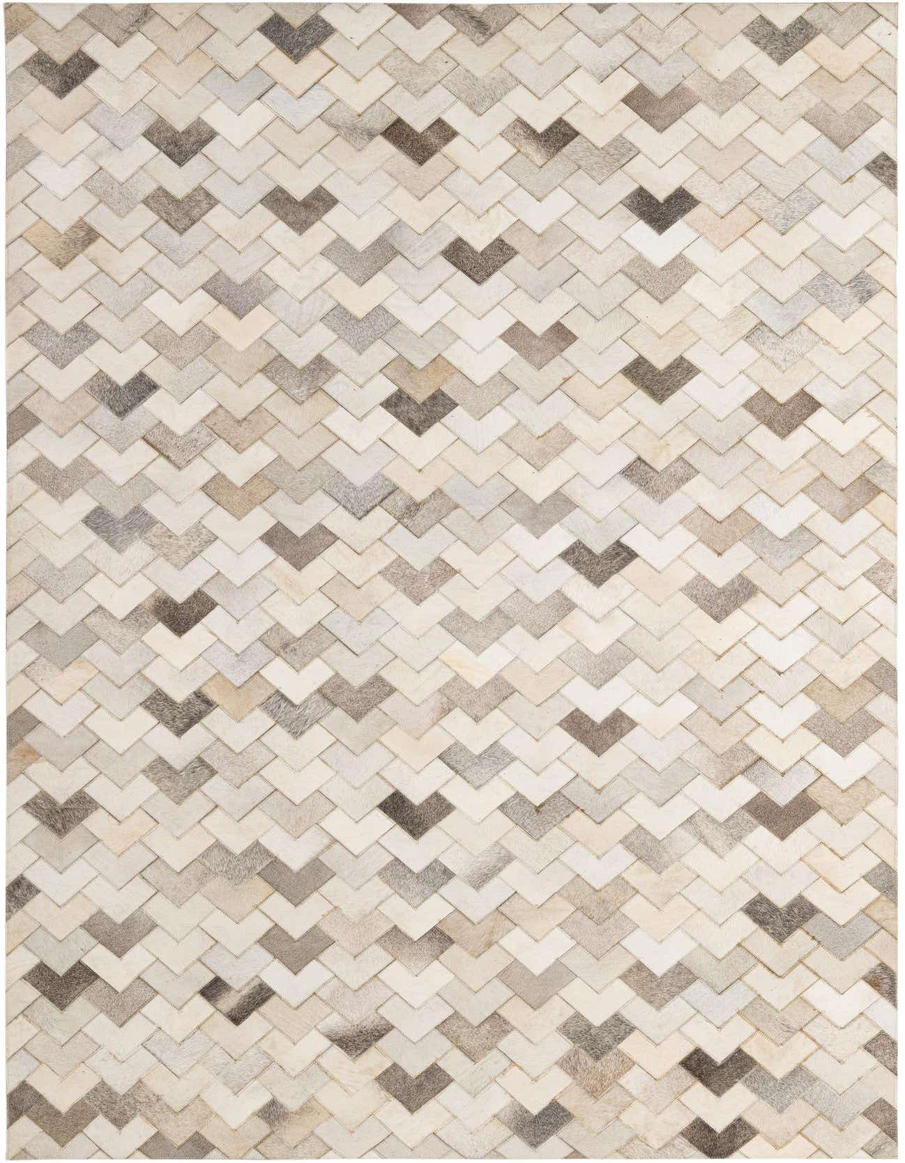 5x8 rectangular Cowhide - Patchwork rug featuring a modern chevron pattern in shades of brown, tan, ivory, and cream.