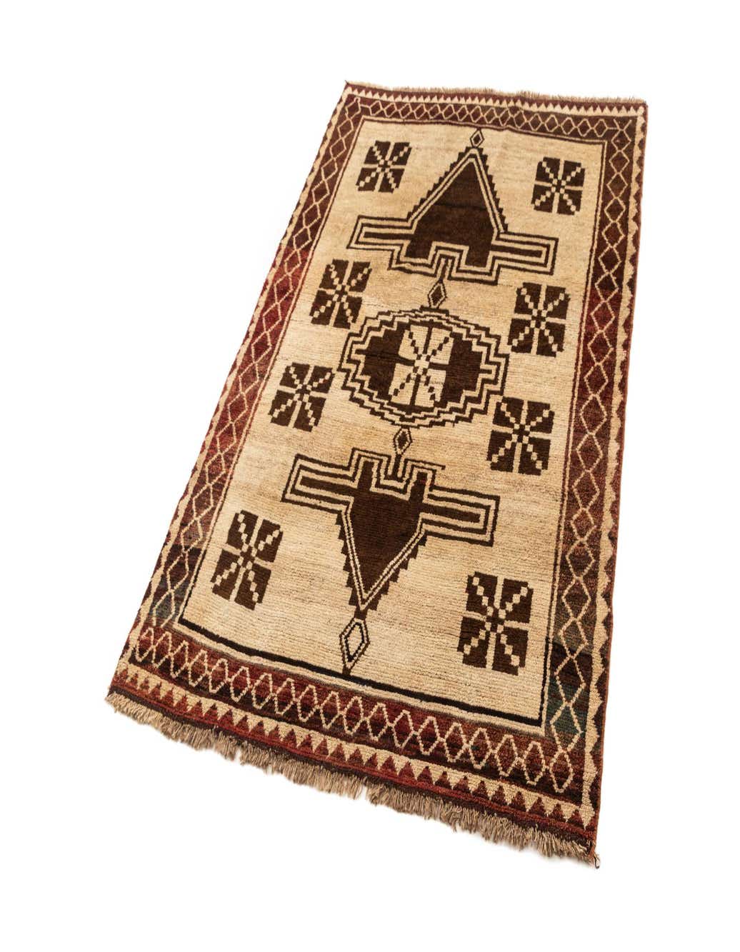 A 4x6 rectangular Gabbeh rug with a modern geometric pattern in brown and tan, featuring a central medallion and border.