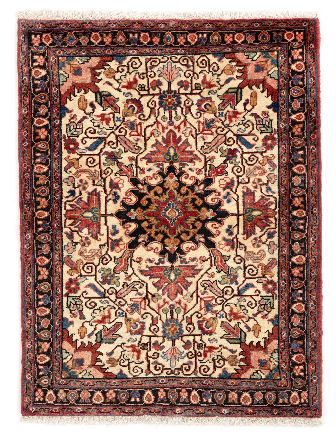 A 3x5 rectangular Heriz rug with a central dark medallion and intricate Persian floral patterns in reds, blues, and creams on a tan background.